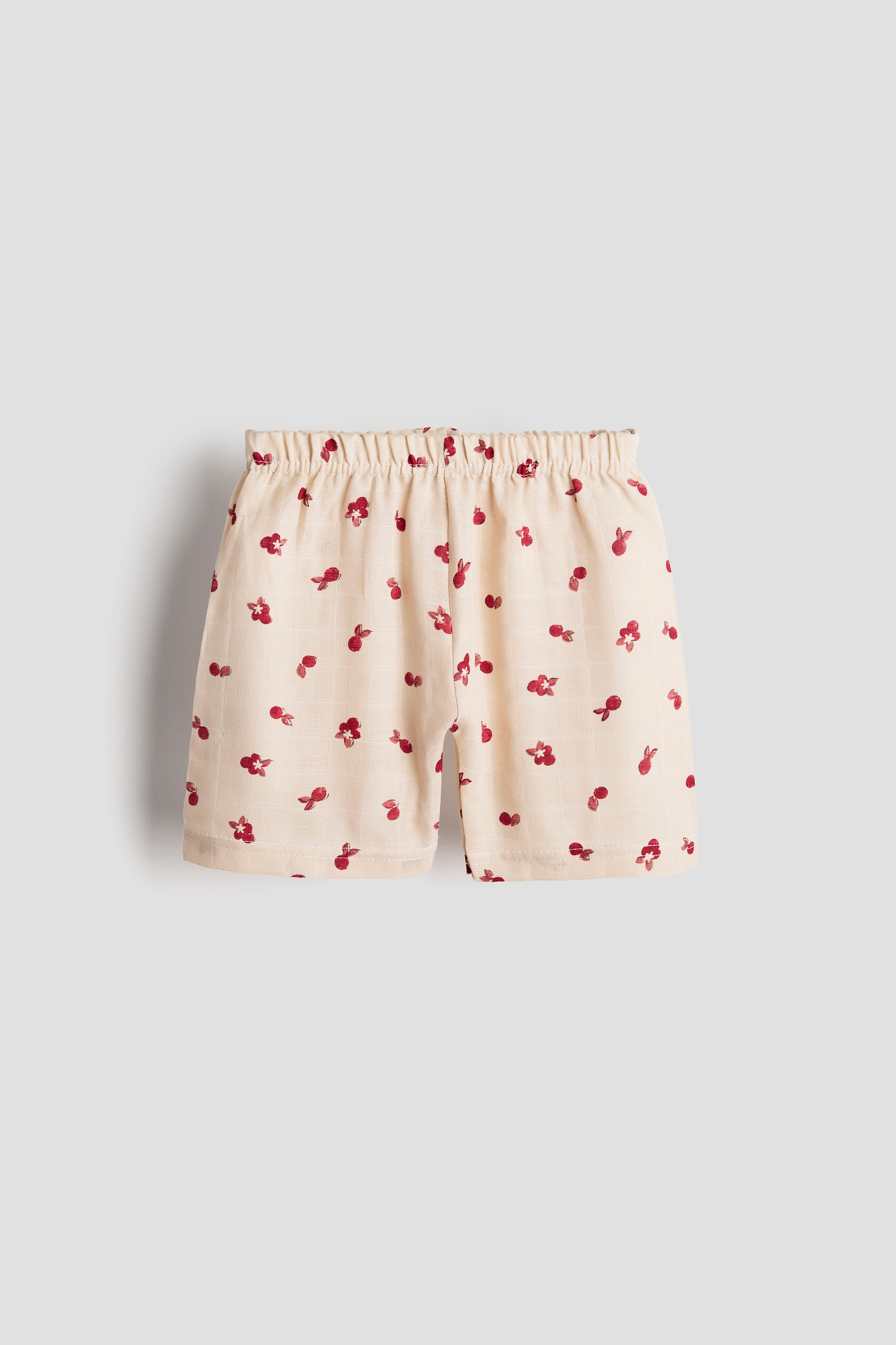 Shorts with cherry pattern on a light gray background