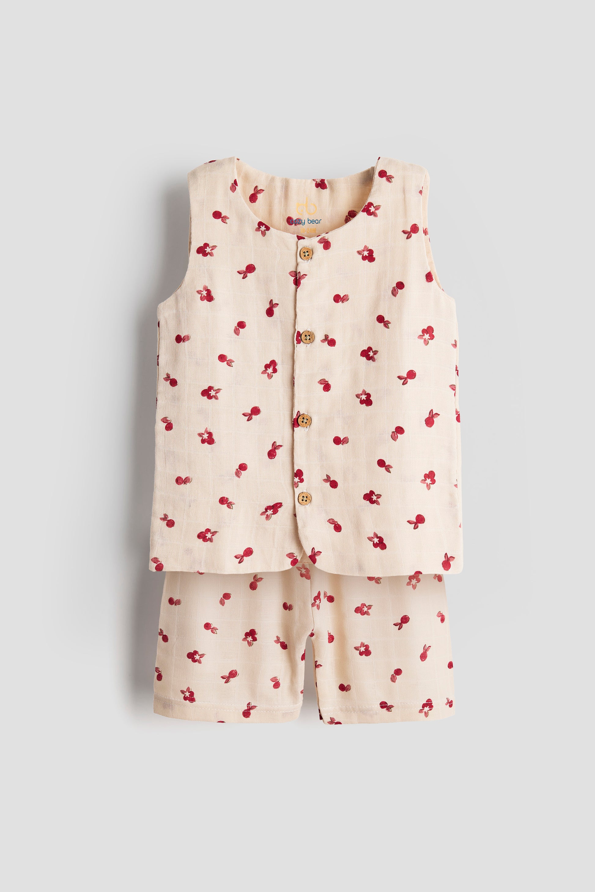 Children's outfit with a sleeveless top and shorts featuring red floral patterns on a light gray background.