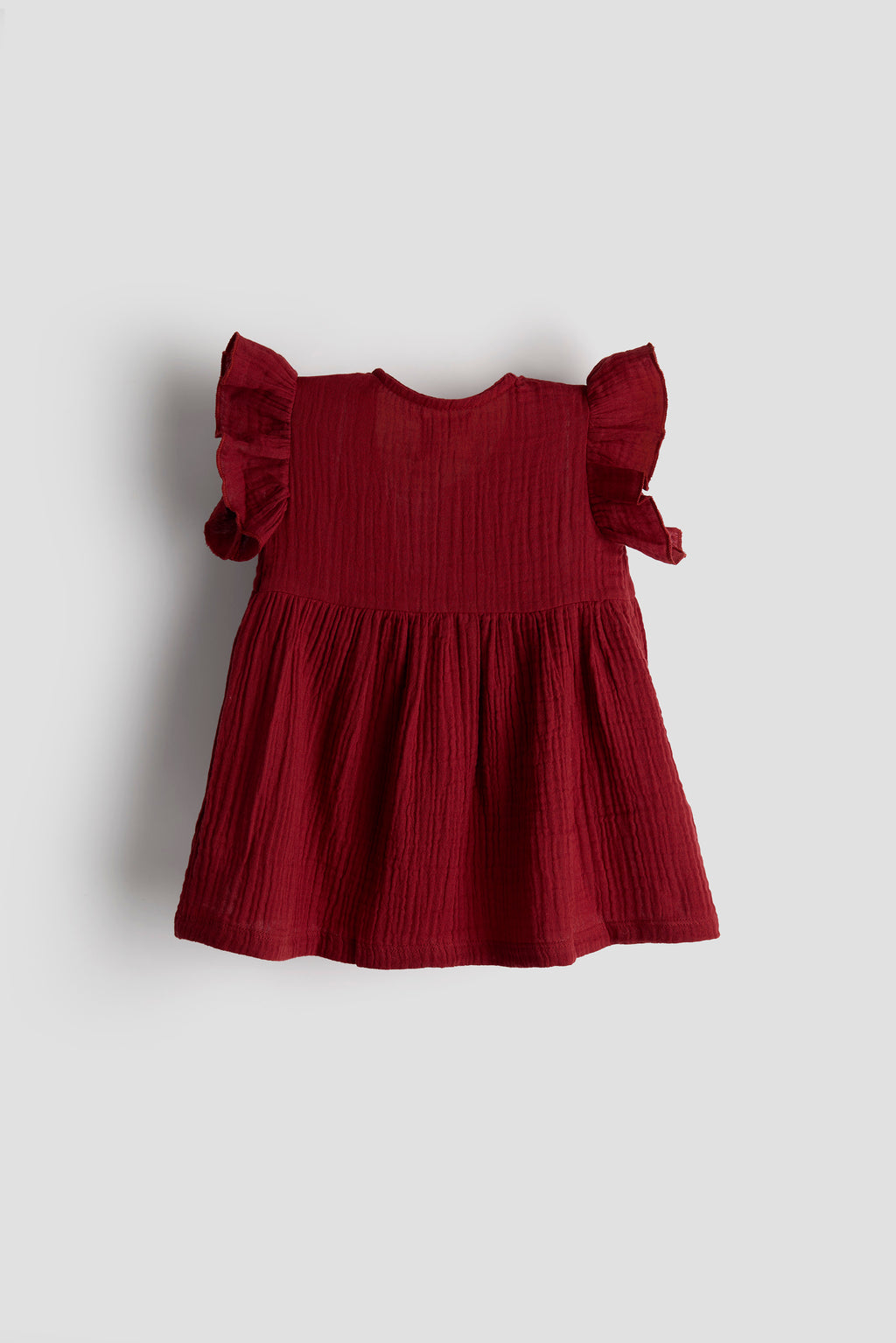 Red dress with ruffled sleeves on a light gray background