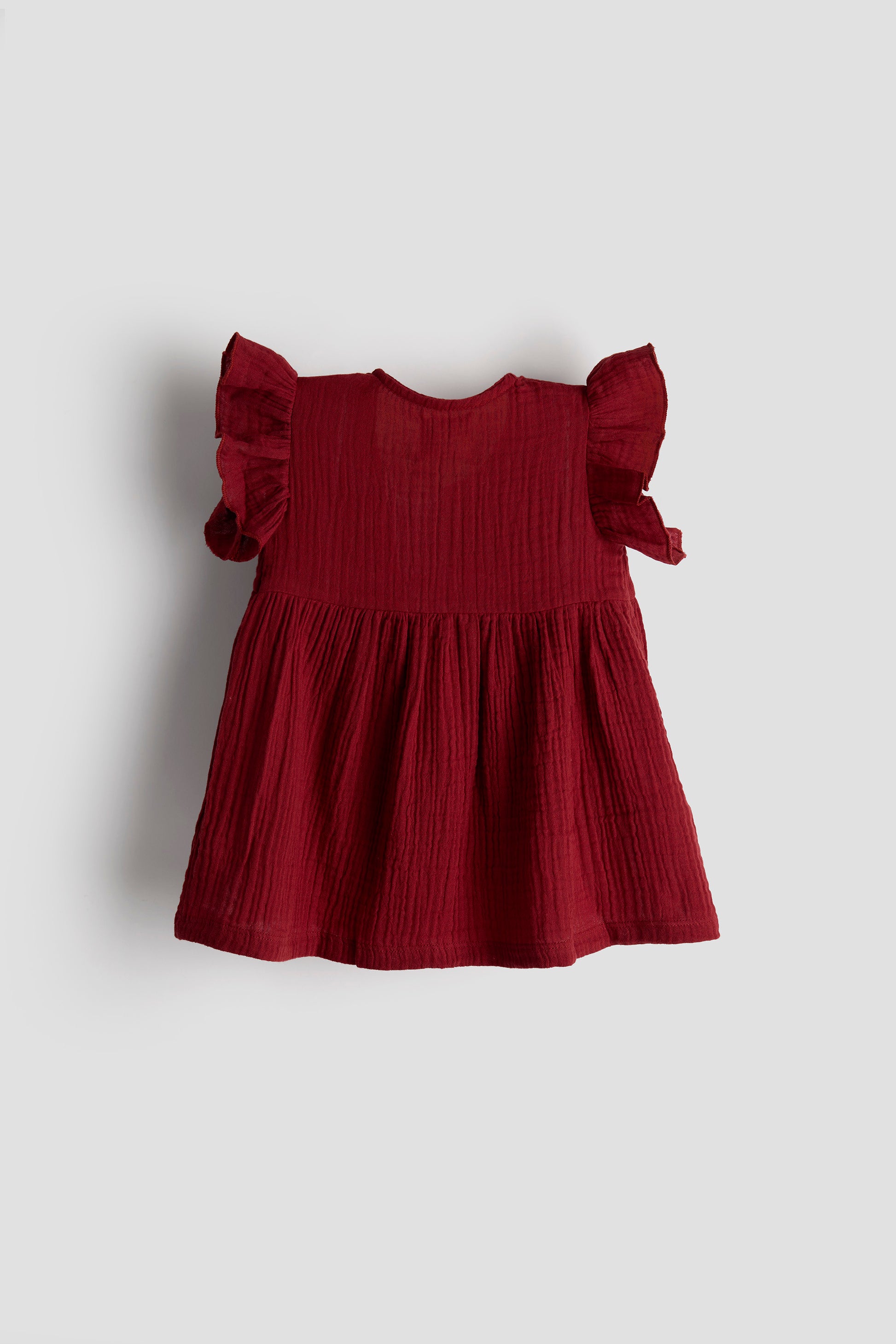 Red dress with ruffled sleeves on a light gray background