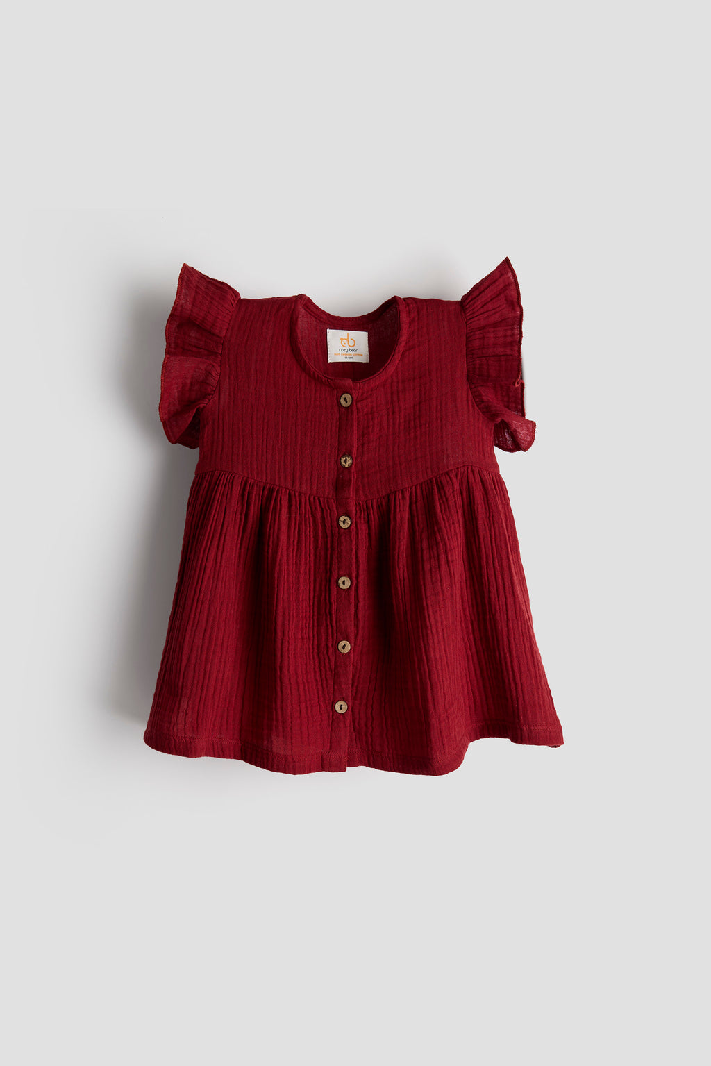 Red dress with ruffled sleeves on a light gray background