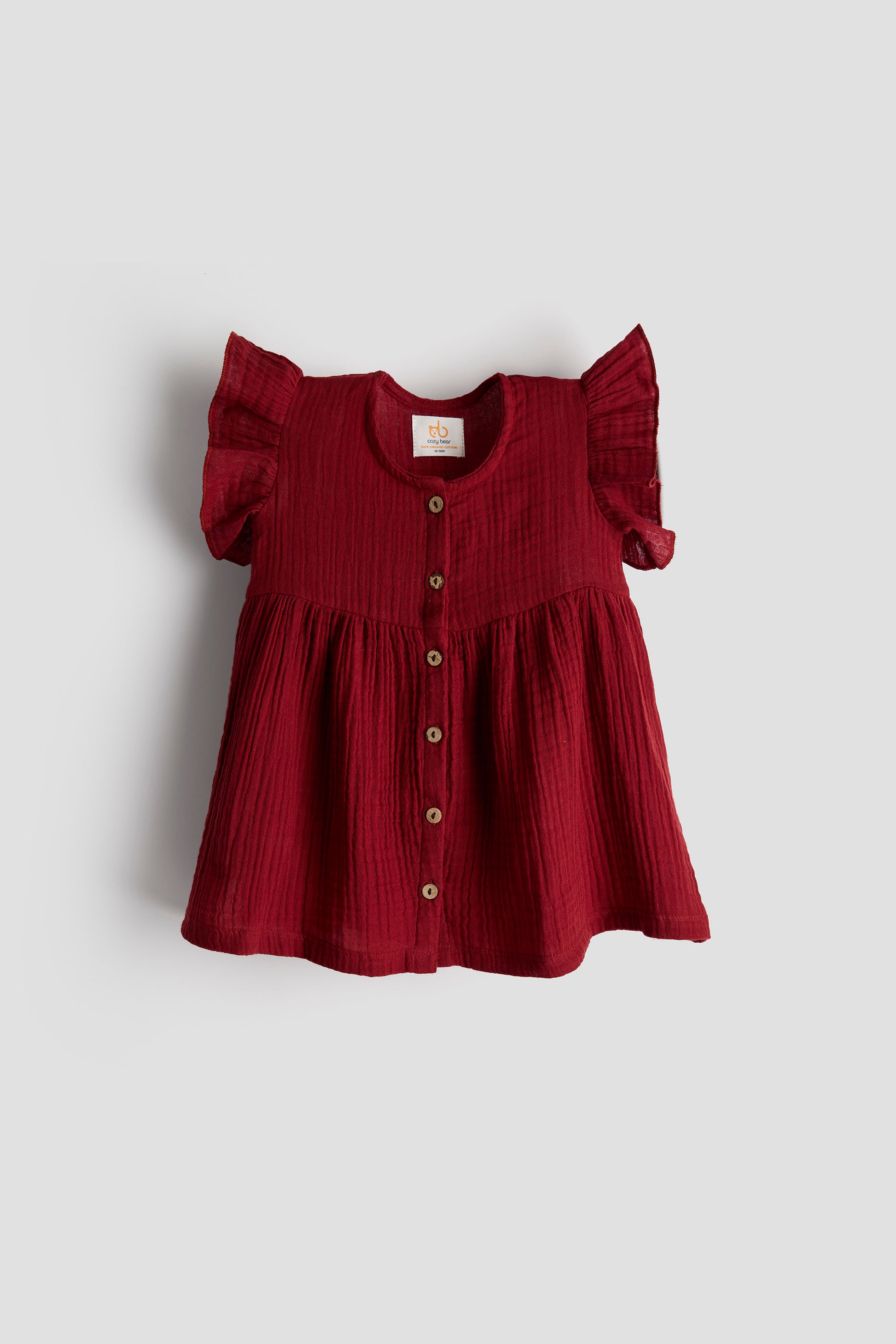 Red dress with ruffled sleeves on a light gray background