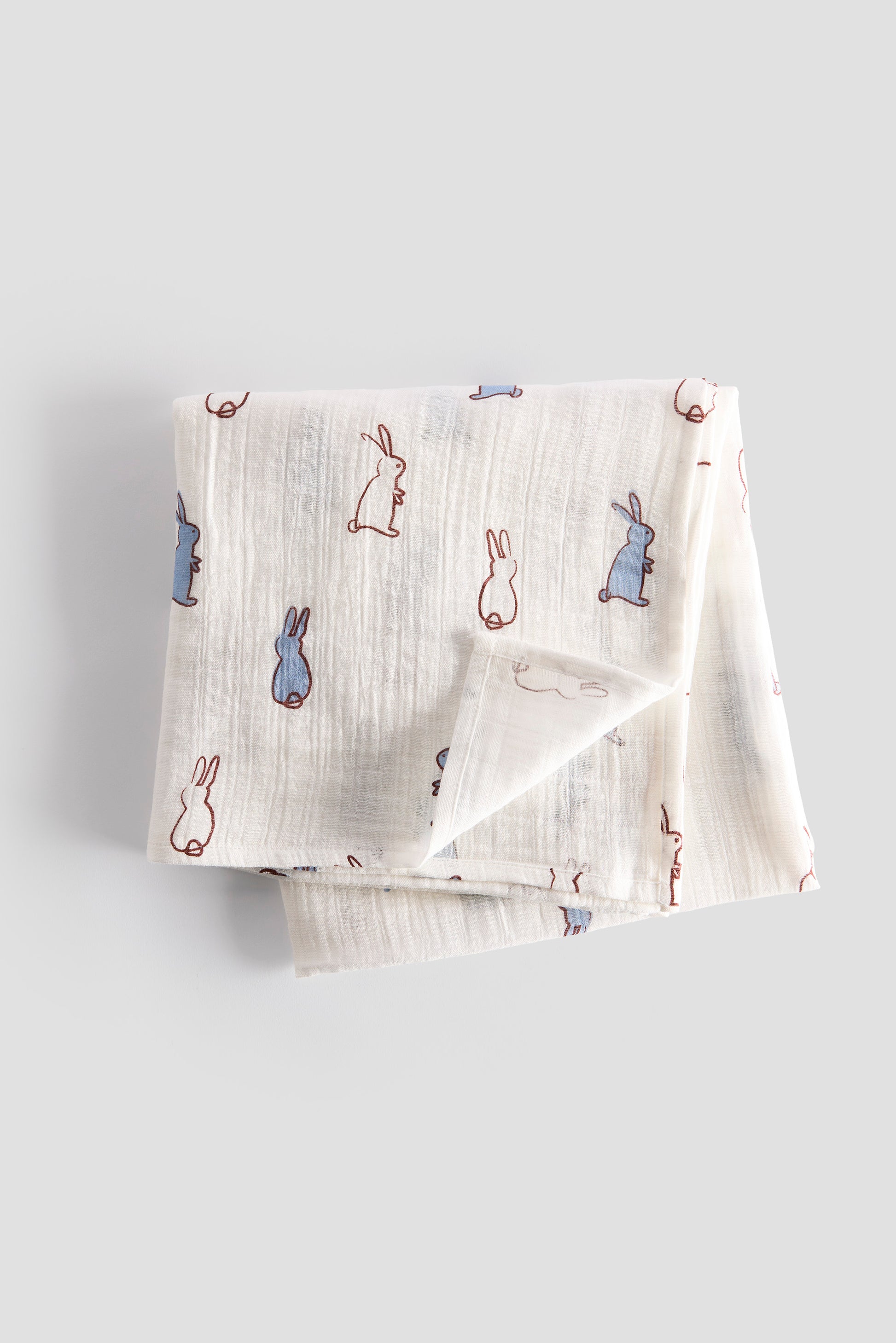 Folded fabric with bunny pattern on a light gray background