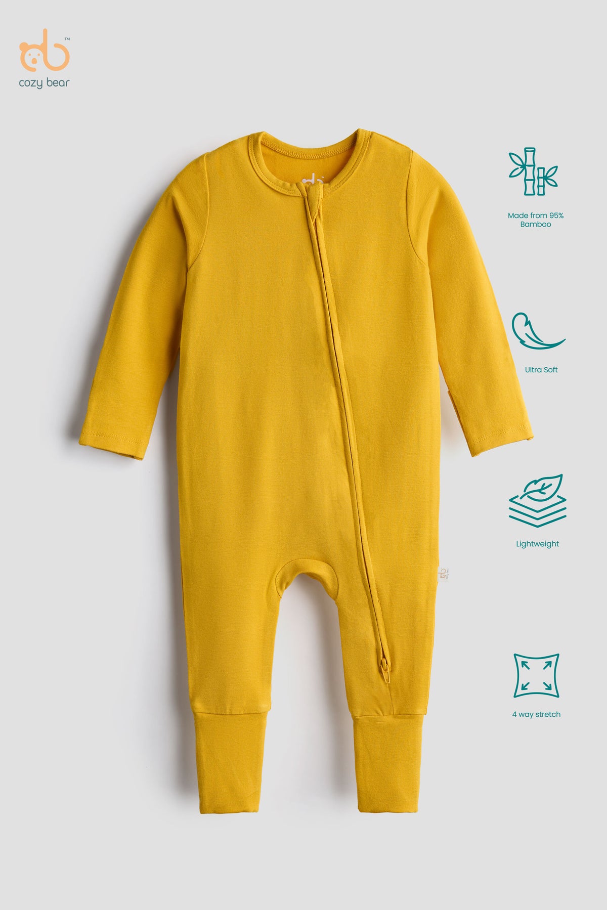 A mustard yellow long-sleeve baby footless one-piece sleeper with a front zipper, displayed on a light gray background with feature icons on the right side.