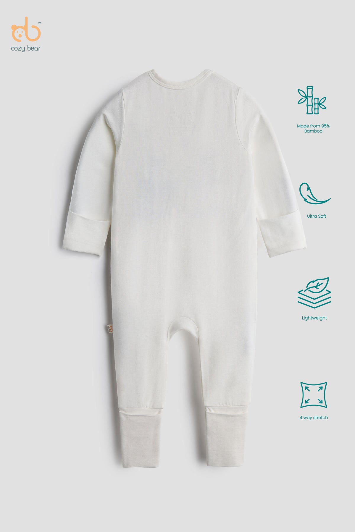 A baby long-sleeve footless one-piece romper in off-white, shown from the back on a light gray background. The image includes feature callout icons on the right side and the 'crazy bear' brand logo in the top left corner.