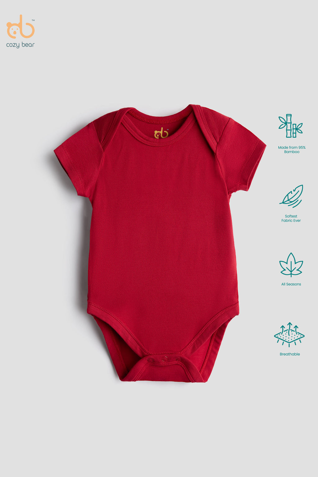 A red short-sleeve baby bodysuit laid flat on a light gray background, with a small gold 'cb' logo printed inside the collar. On the right side, teal icons highlight features such as organic cotton fabric, soft natural feel, breathable mesh, and gentle baby skin care.