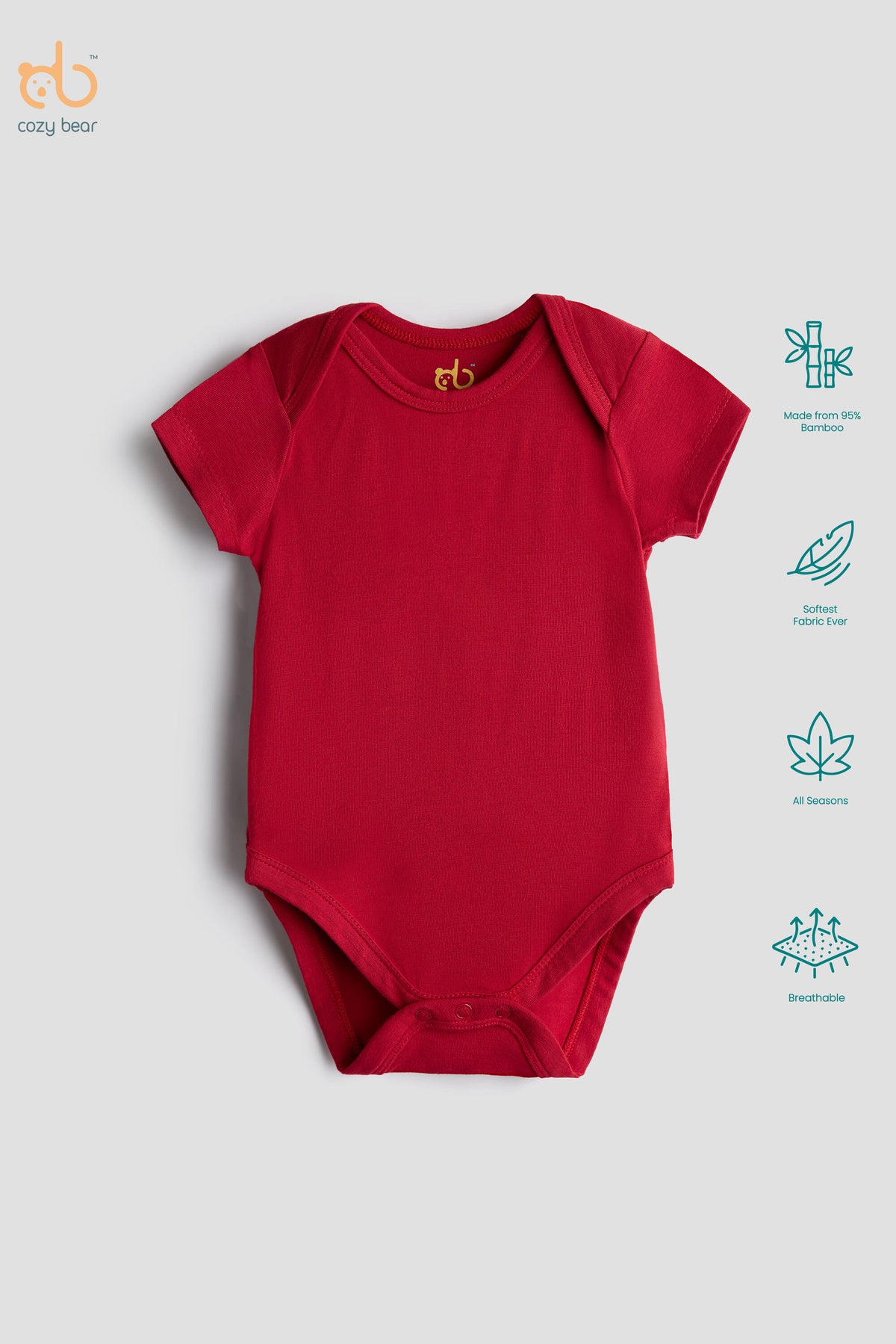 A red short-sleeve baby bodysuit laid flat on a light gray background, with a small gold 'cb' logo printed inside the collar. On the right side, teal icons highlight features such as organic cotton fabric, soft natural feel, breathable mesh, and gentle baby skin care.