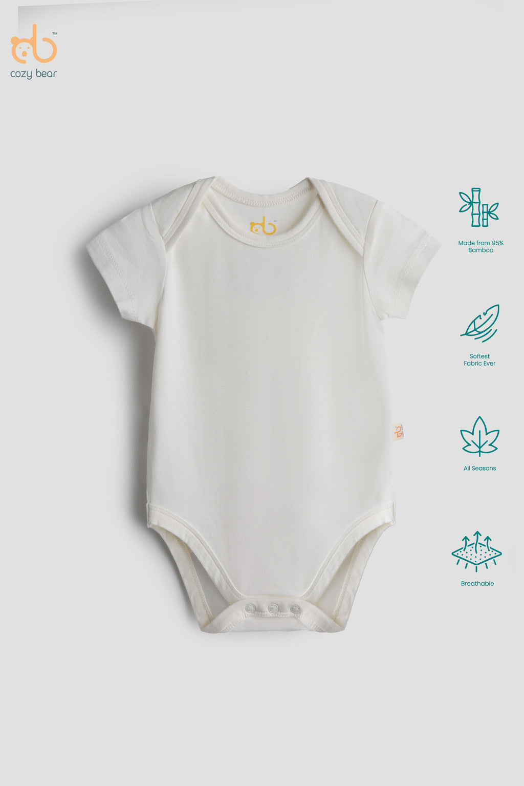 An off-white short-sleeve baby bodysuit by cozy bear, displayed flat against a light gray background with feature icons on the right.