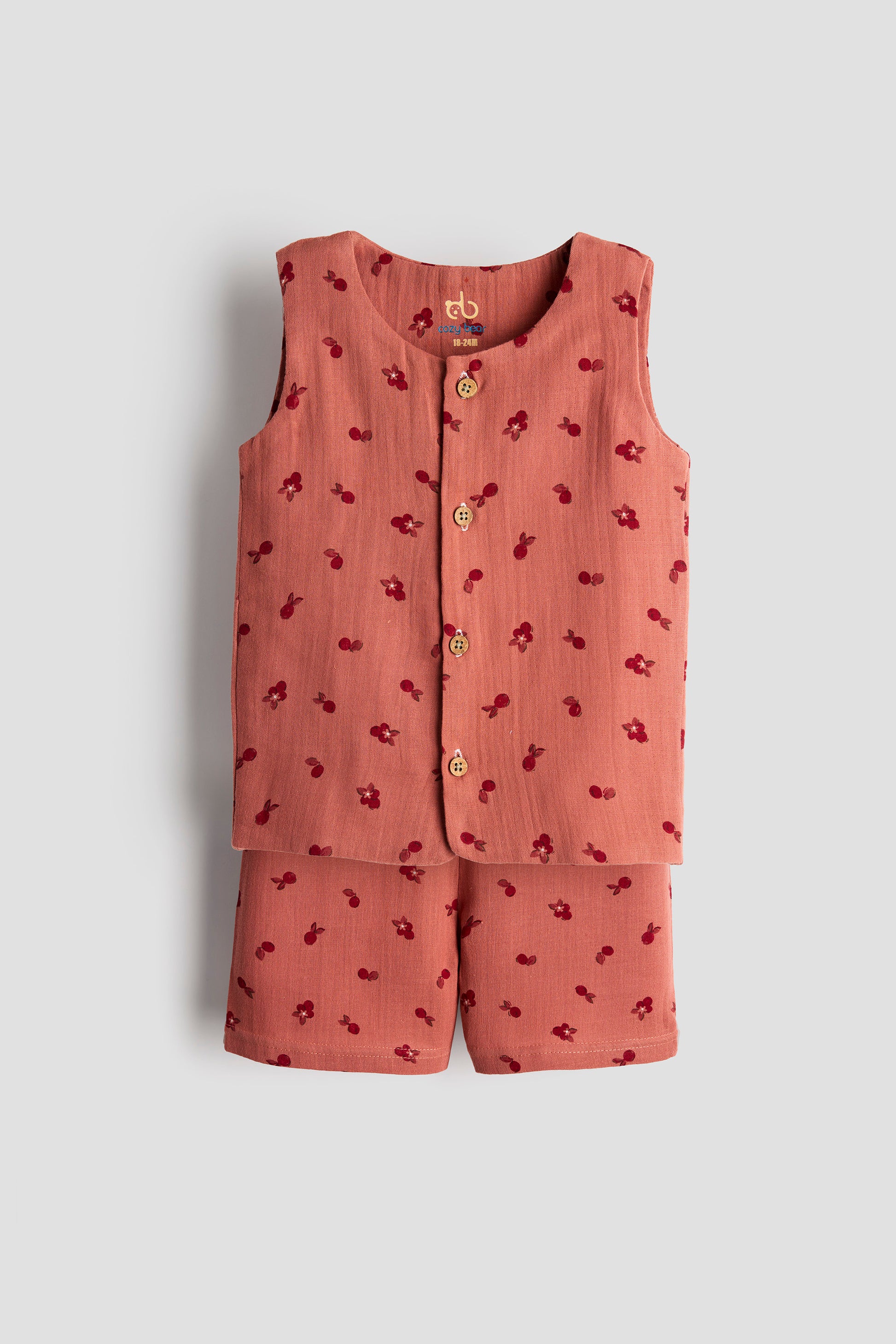 Children's pink outfit with a sleeveless top and shorts on a light gray background