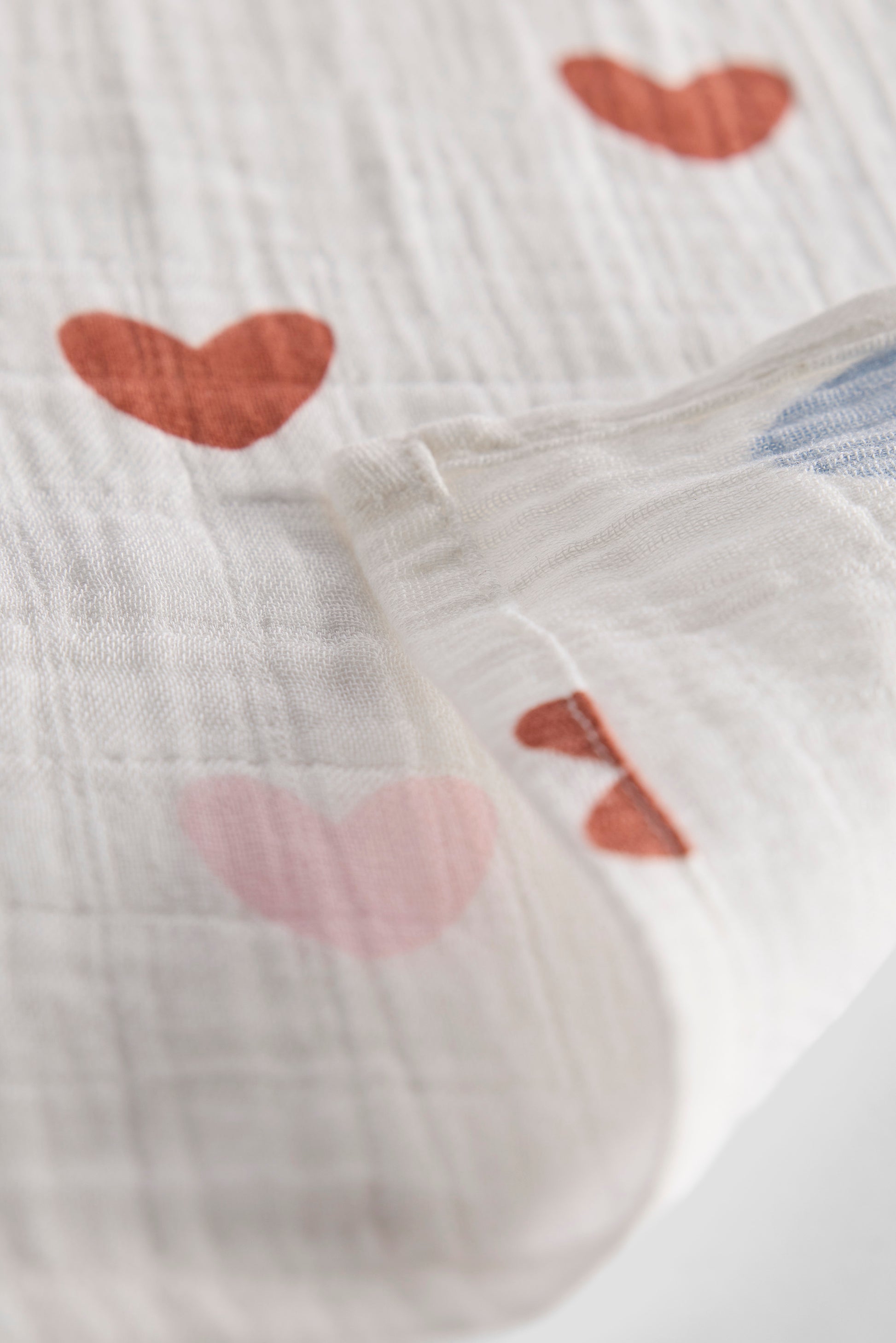 Textured fabric with heart patterns on a white background