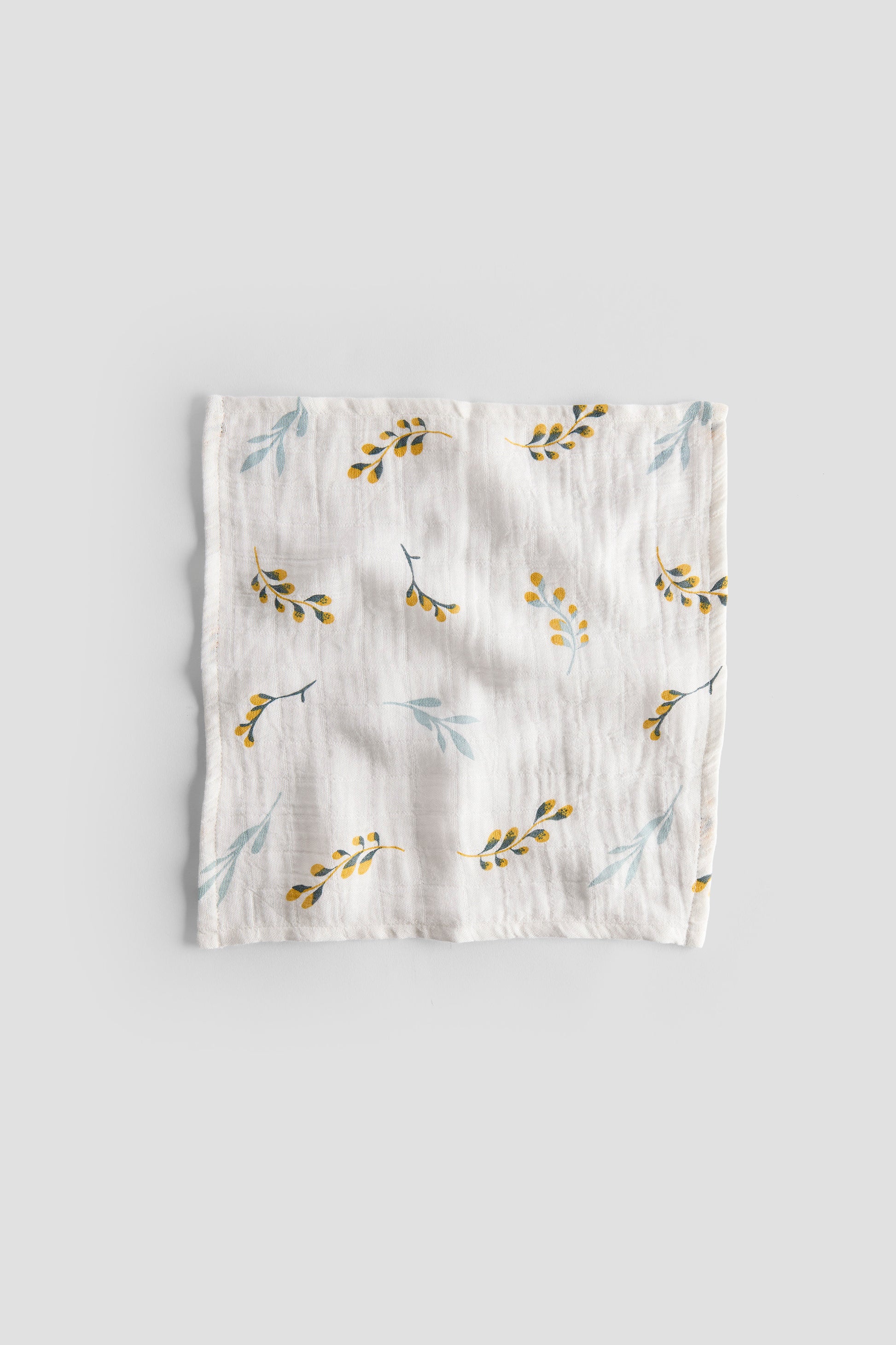 Floral patterned baby blanket on a light gray background