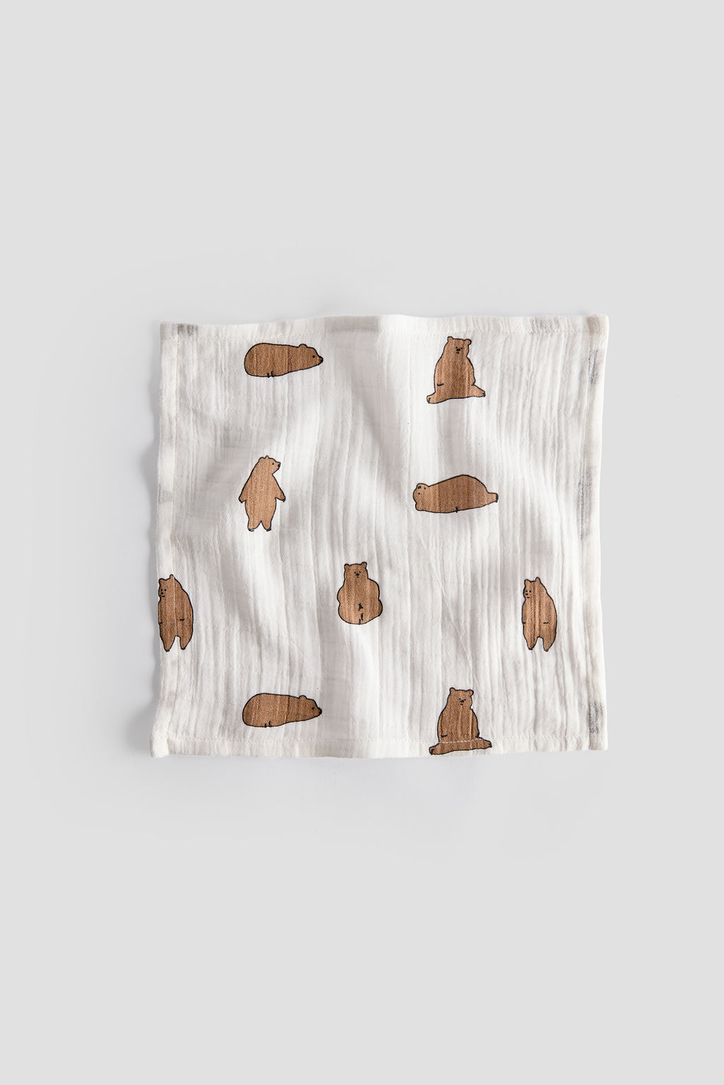 Baby blanket with brown bear pattern on a light gray background