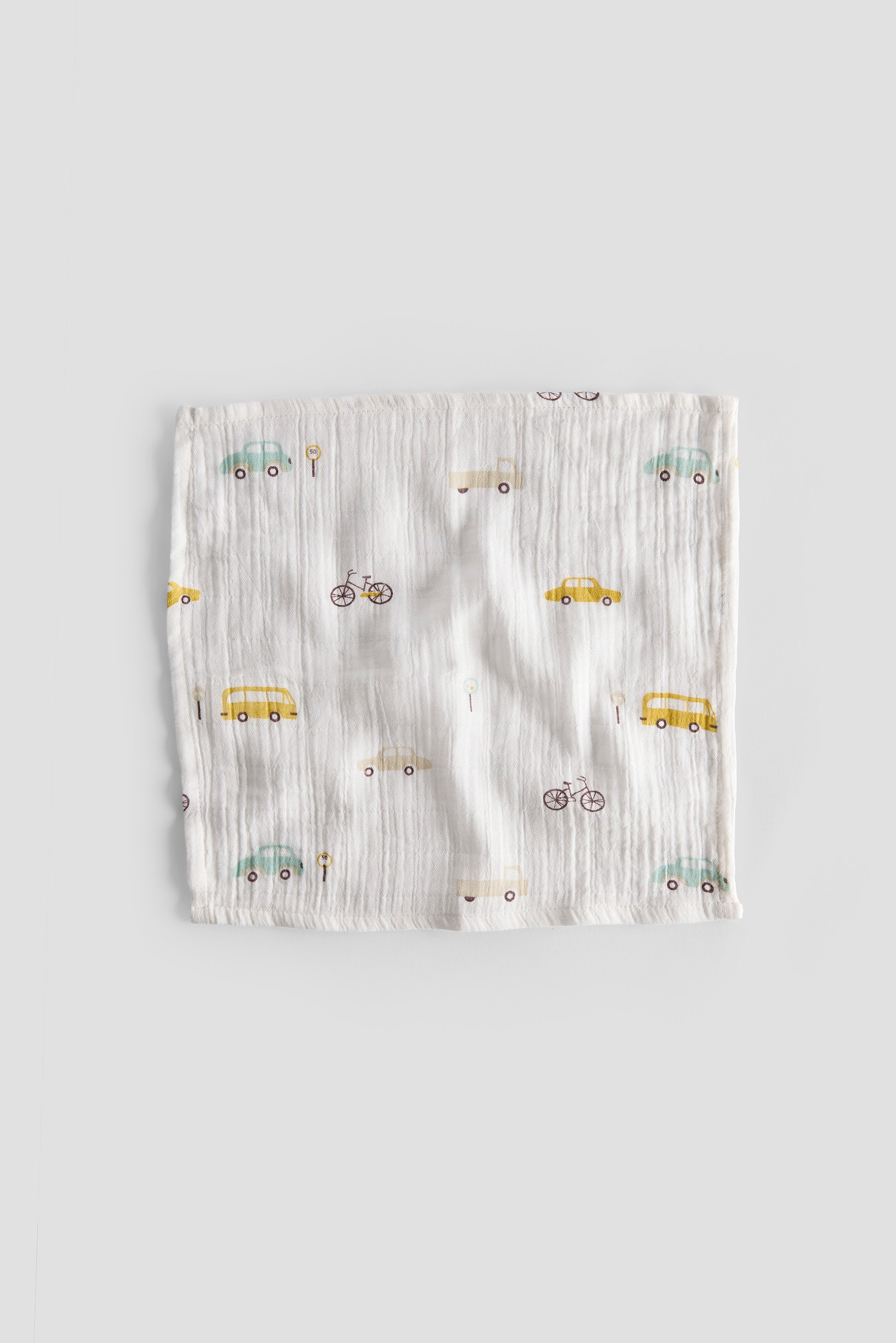 Baby romper with vehicle pattern on a light gray background