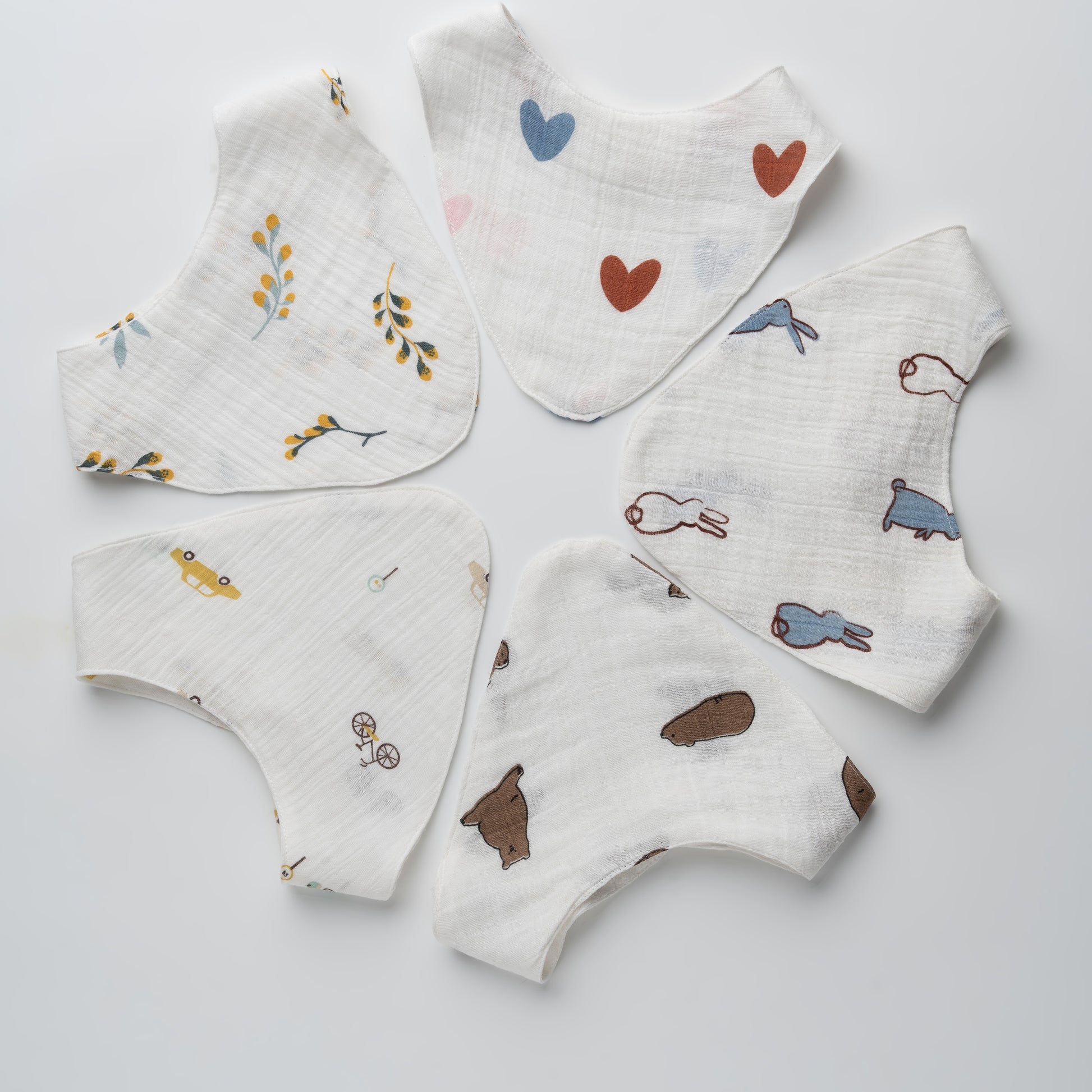 Set of baby bibs with various patterns on a light gray background
