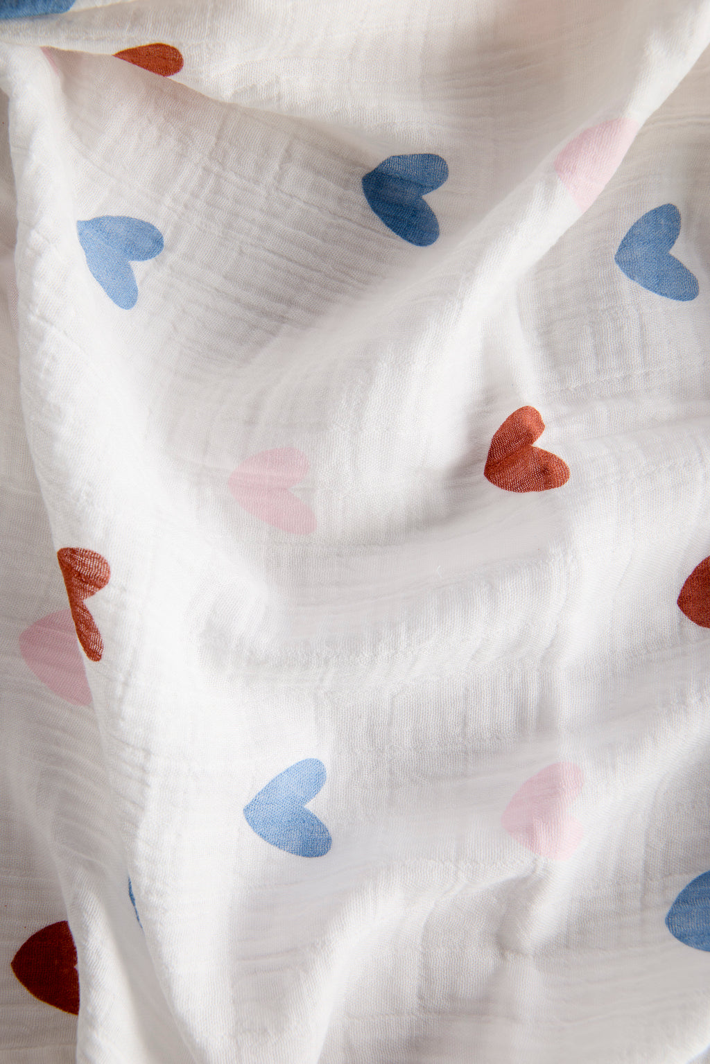 White fabric with colorful heart patterns