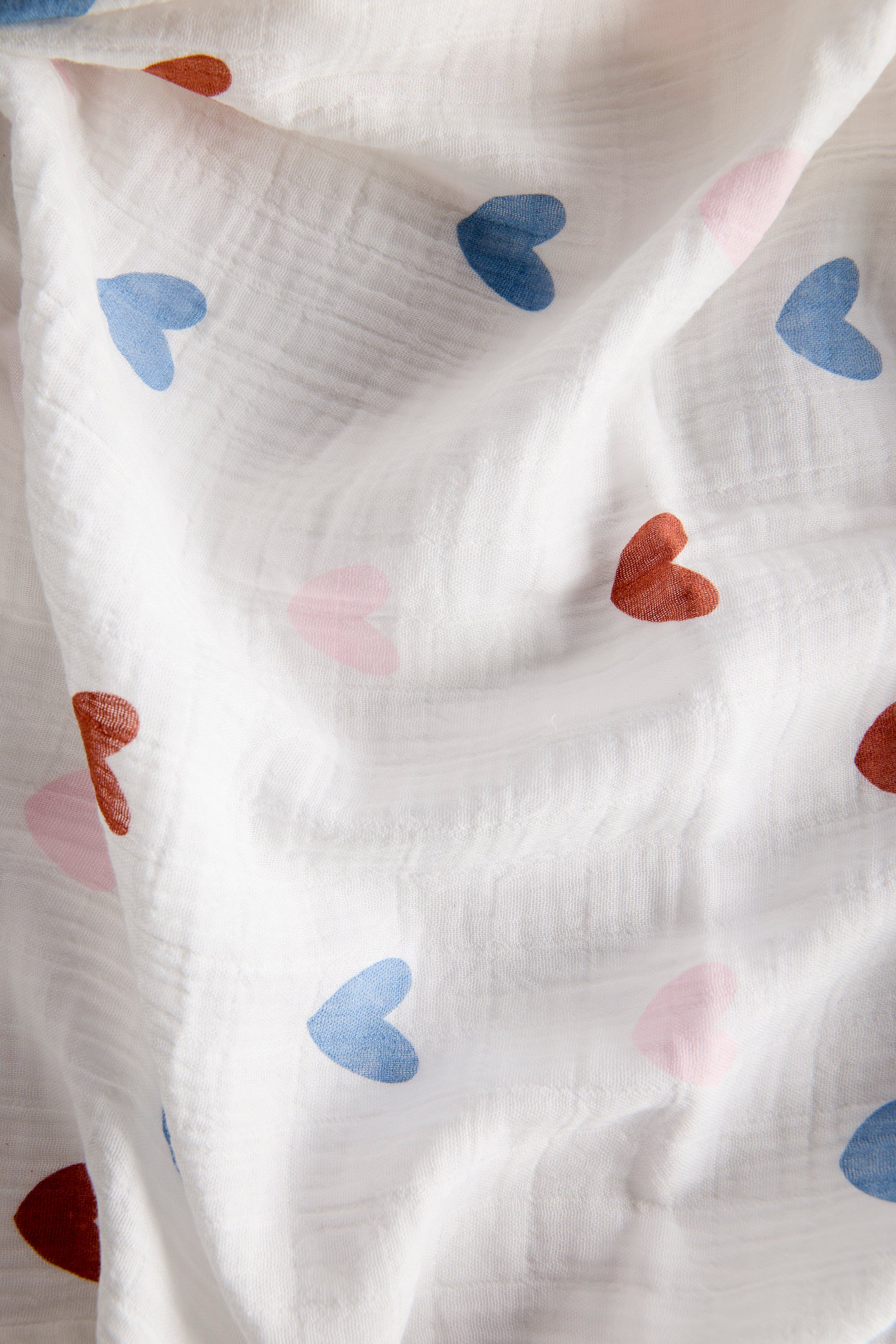 White fabric with colorful heart patterns