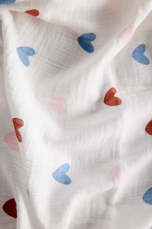White fabric with colorful heart patterns