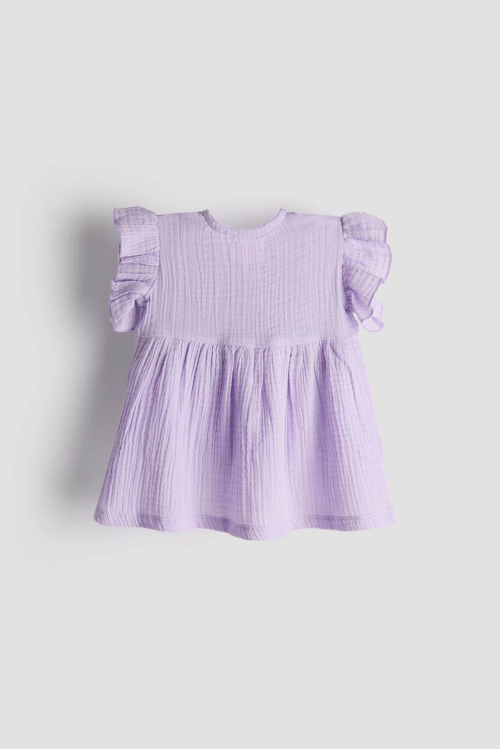 Lavender dress with ruffled sleeves on a light gray background