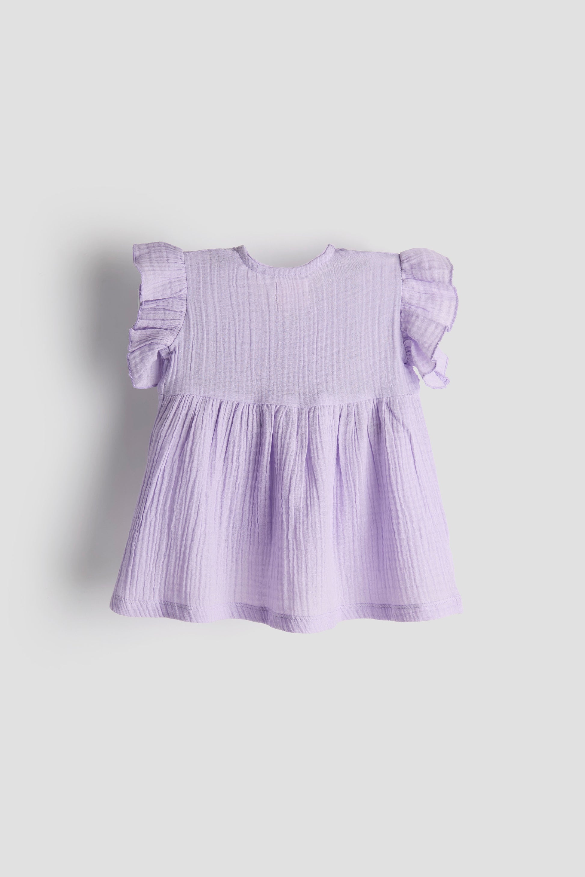 Lavender dress with ruffled sleeves on a light gray background