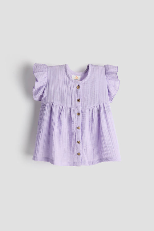 Lavender blouse with ruffled sleeves on a light gray background