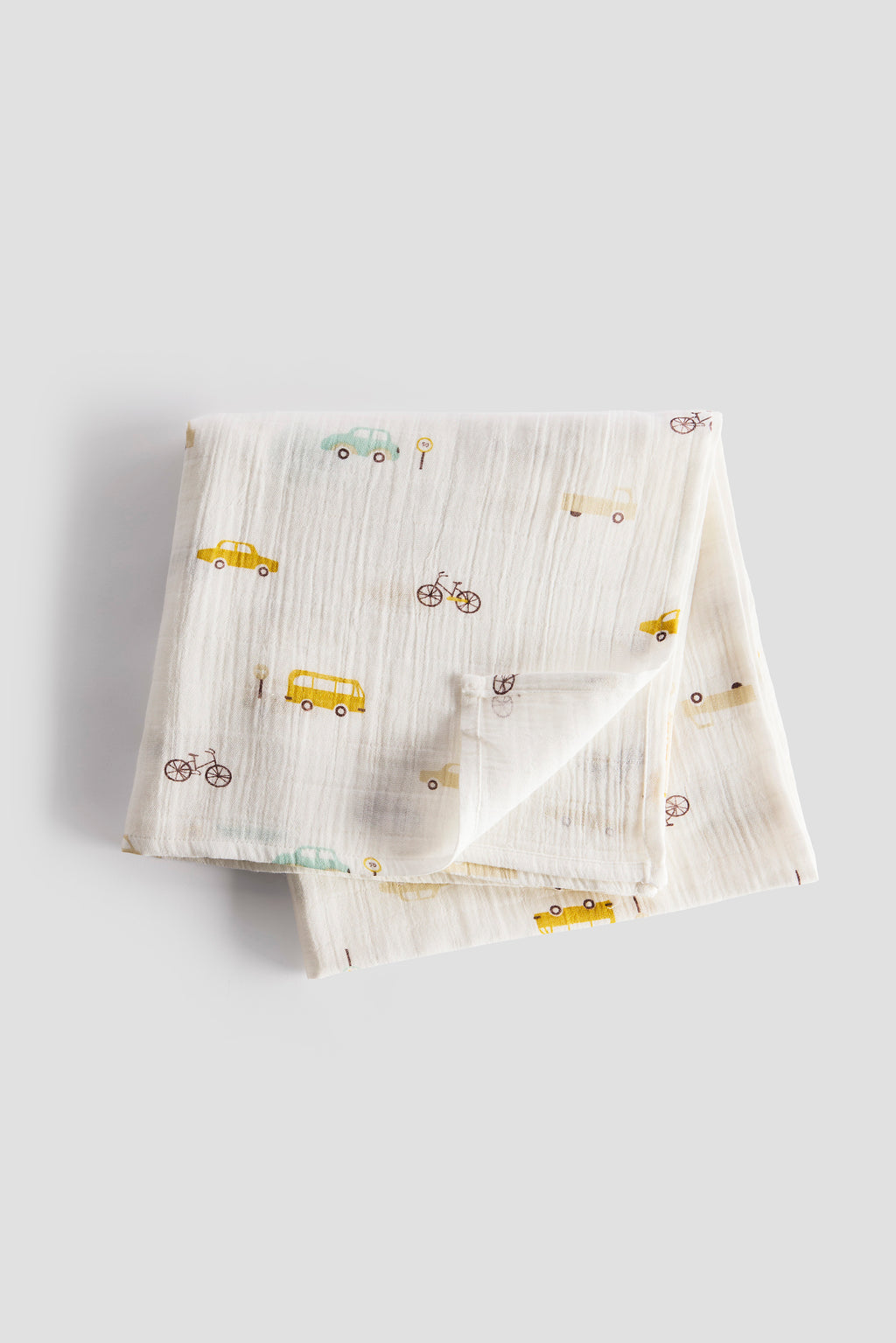 Folded fabric with vehicle patterns on a light gray background