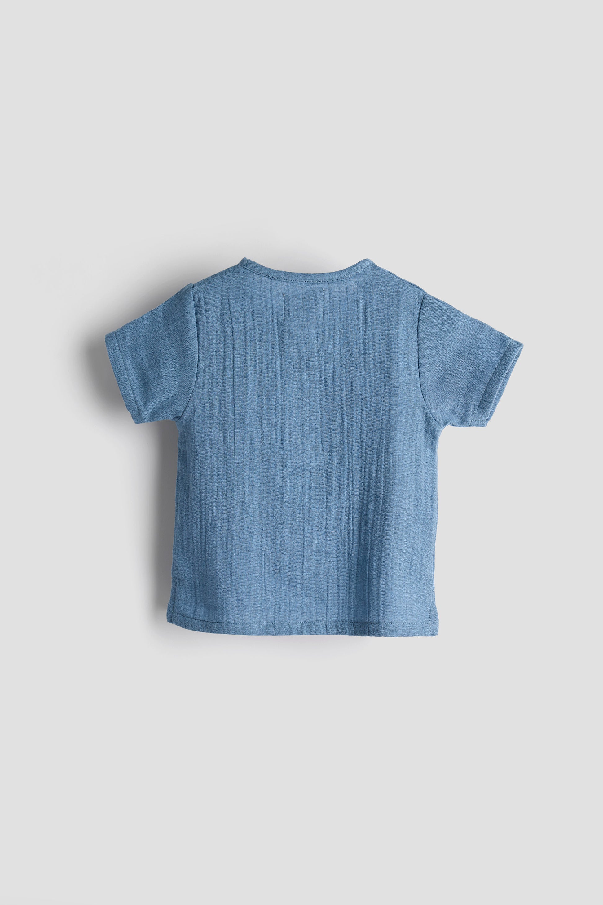 Blue t-shirt on a light gray background