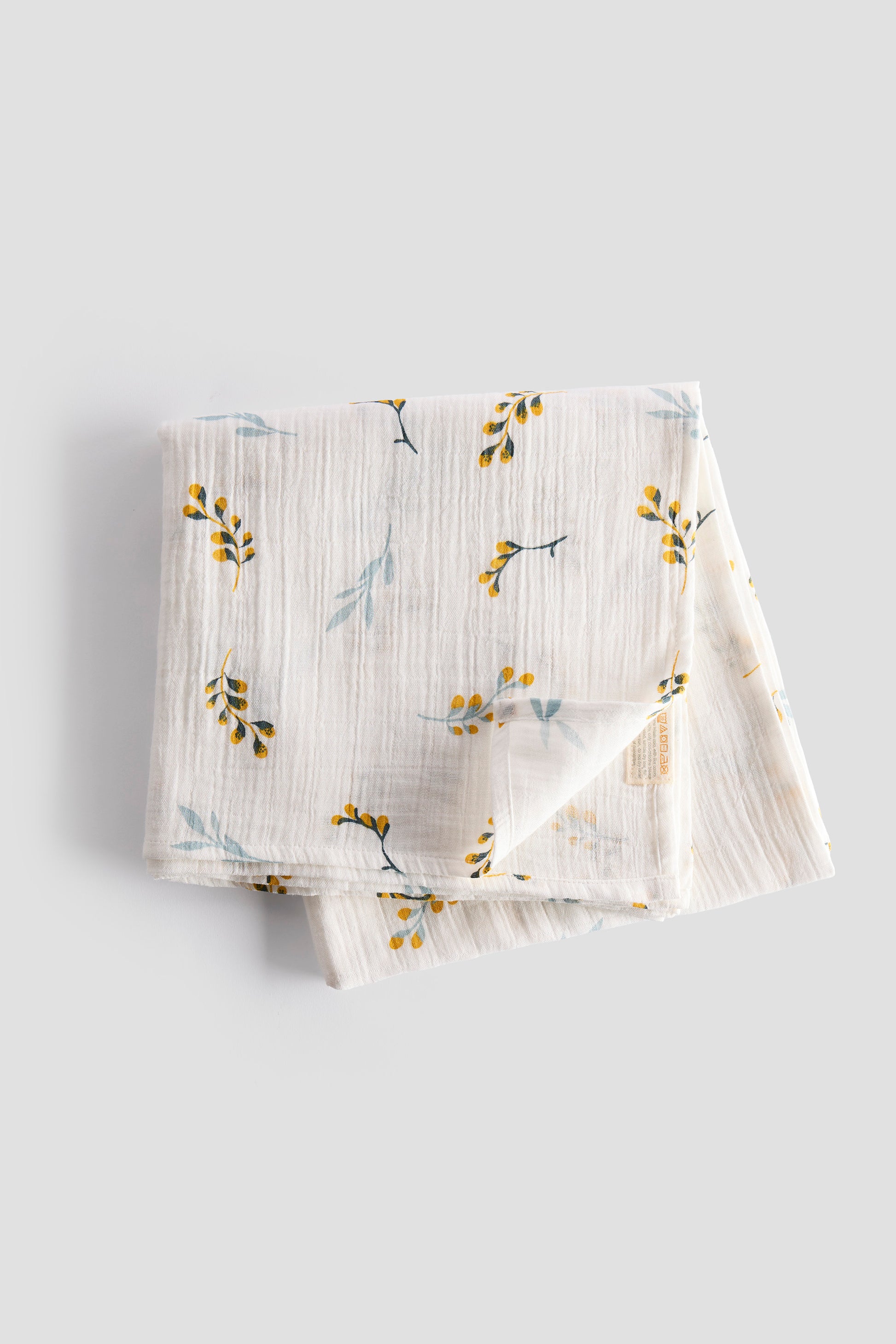 Folded fabric with floral pattern on a light gray background