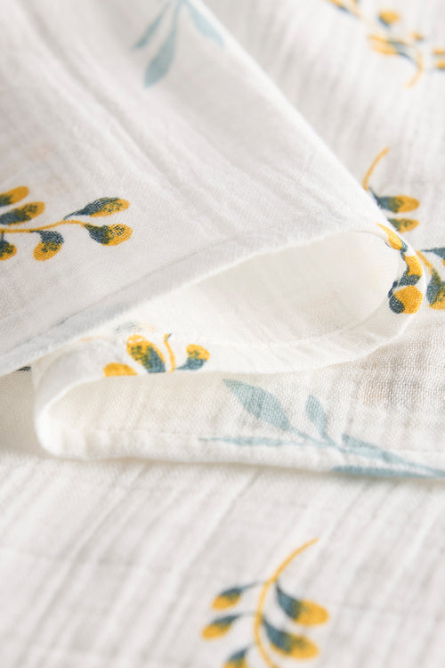 Close-up of a folded fabric with floral patterns on a light background