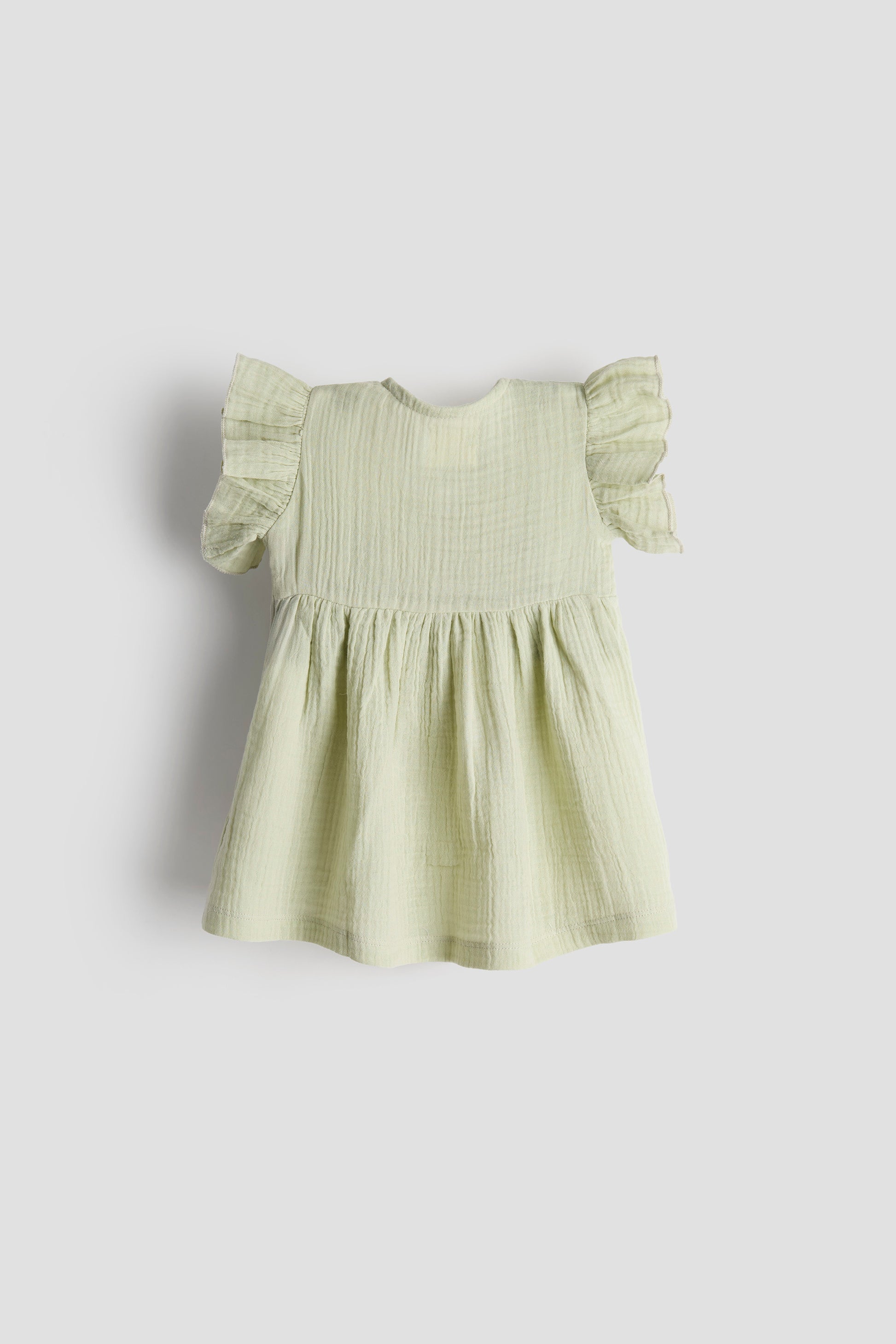 Light green dress with ruffled sleeves on a white background