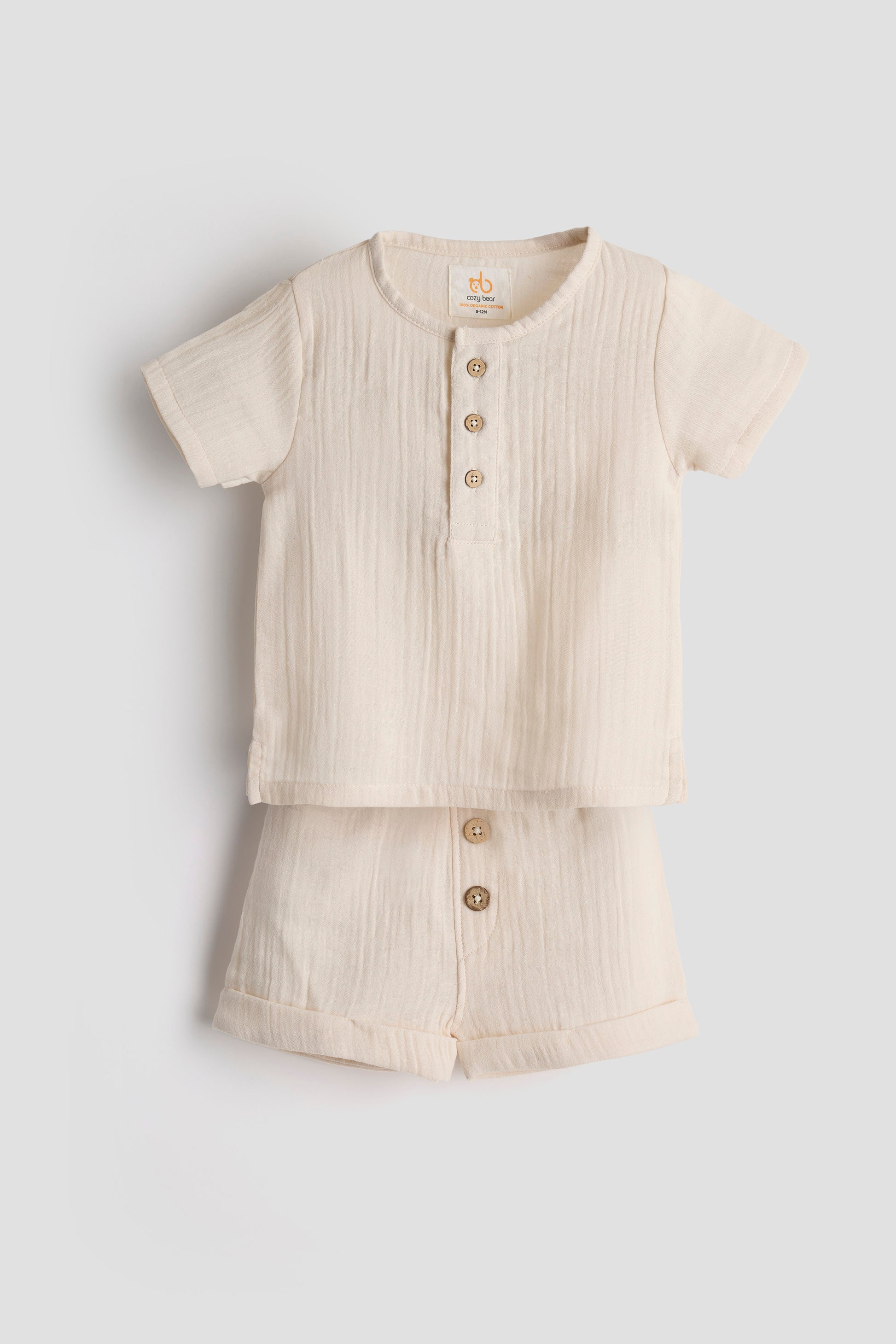 Beige button-up shirt on a light gray background