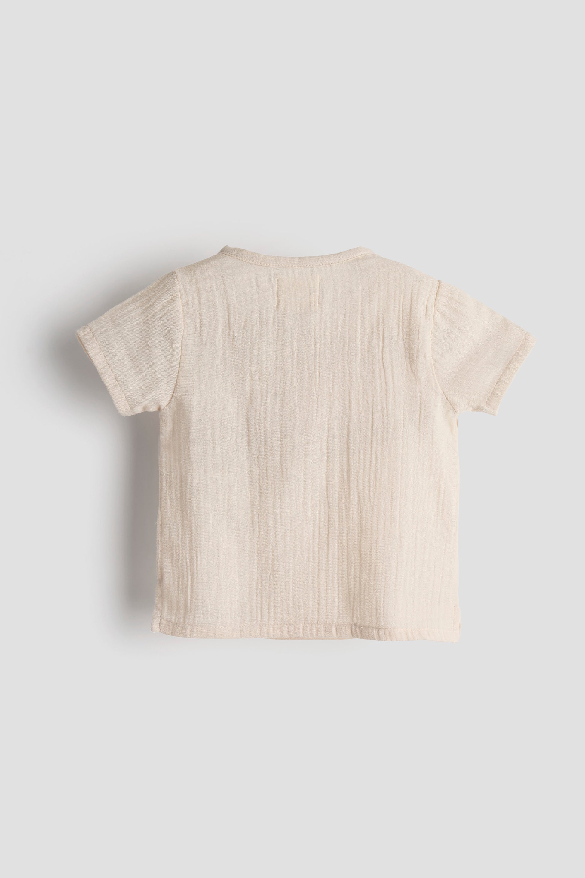 Beige t-shirt on a light gray background