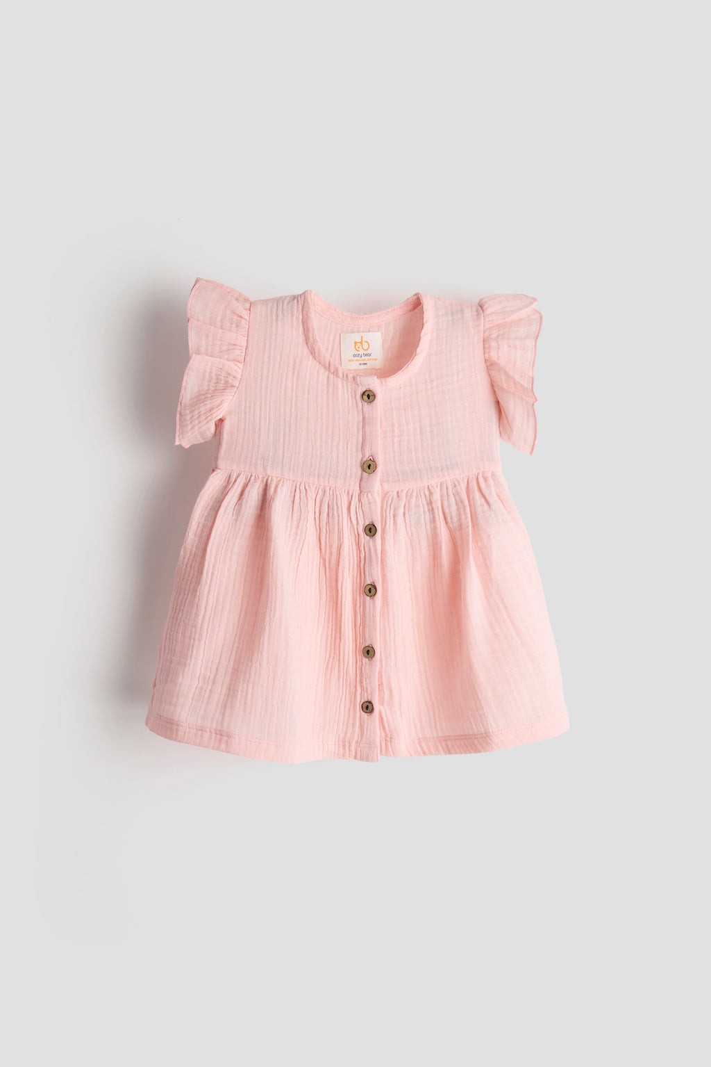 Pink dress with buttons on a light gray background