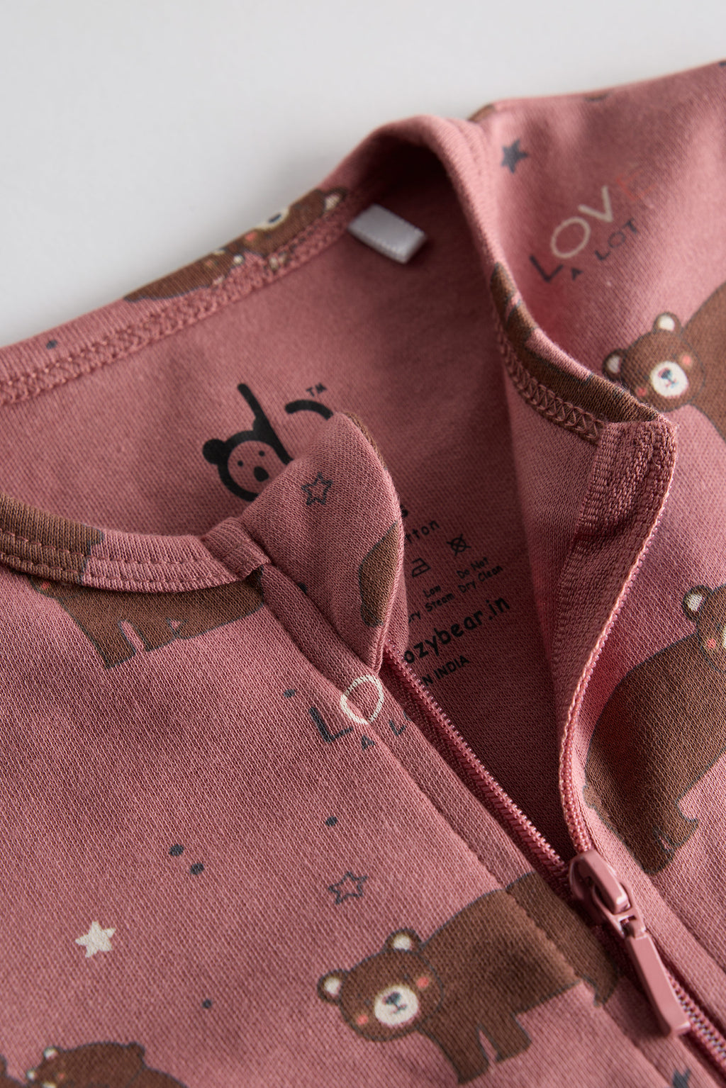 Berry-colored organic cotton baby sleep suit with cute bear print and zipper, by Cozy Bear.