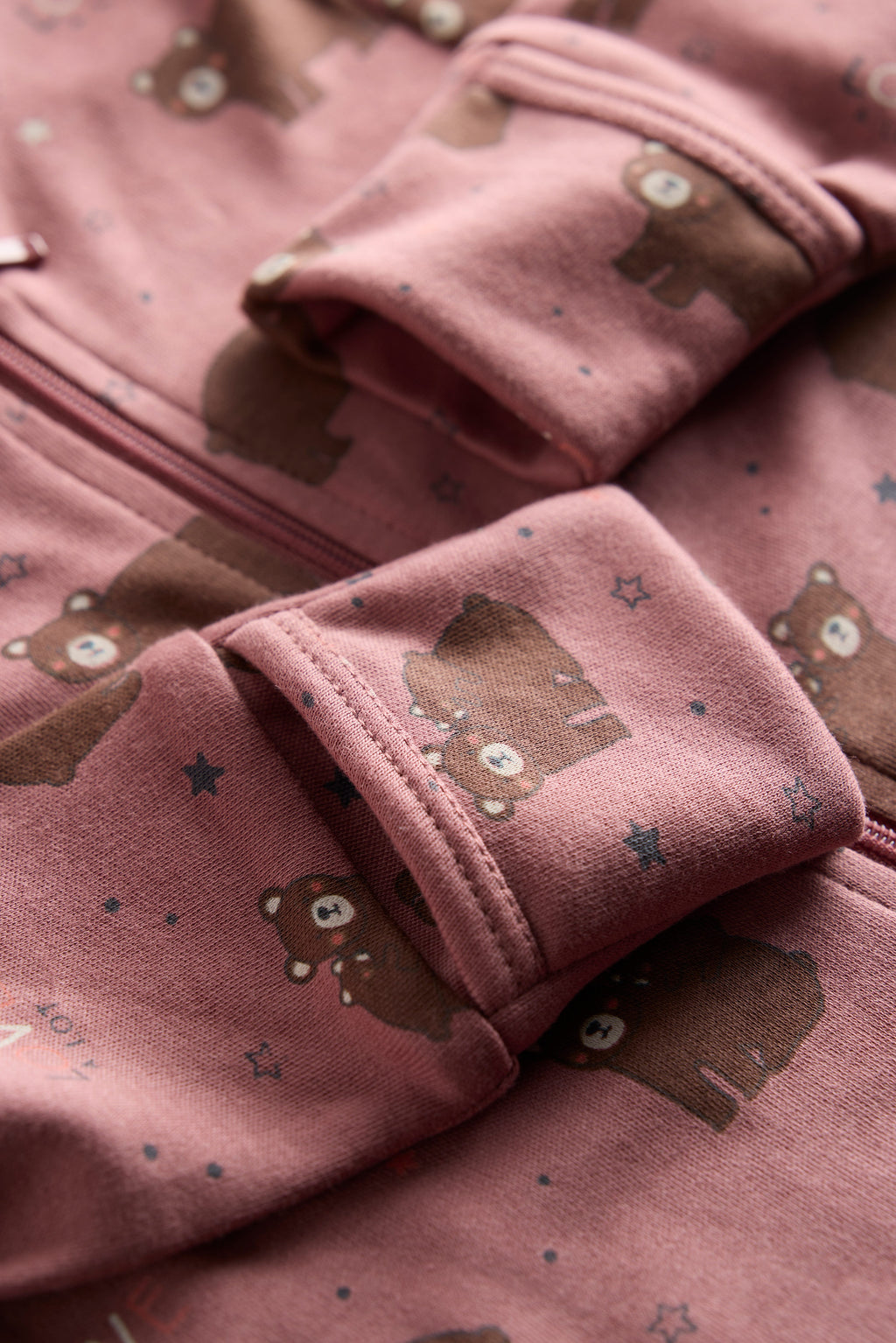 Berry-colored organic cotton baby sleep suit with cute bear print and zipper, by Cozy Bear.