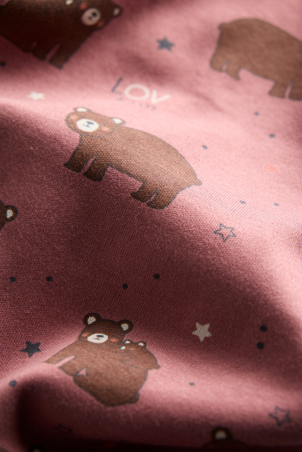 Berry-colored organic cotton baby sleep suit with cute bear print and zipper, by Cozy Bear.