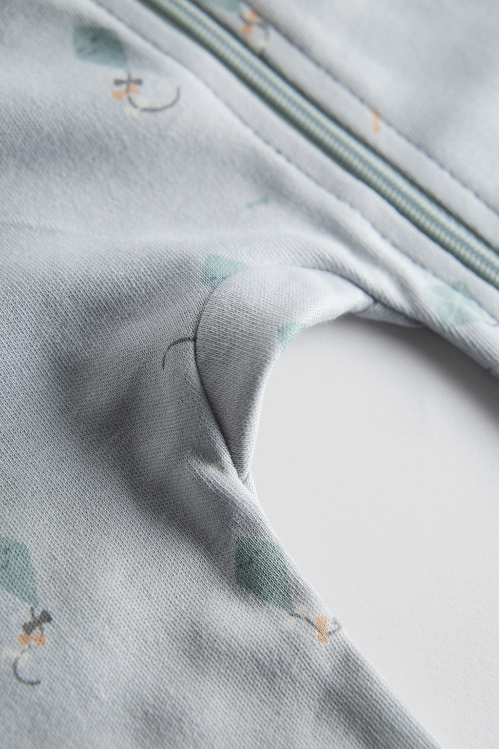 Close-up of a textured fabric with small patterns on a light gray background