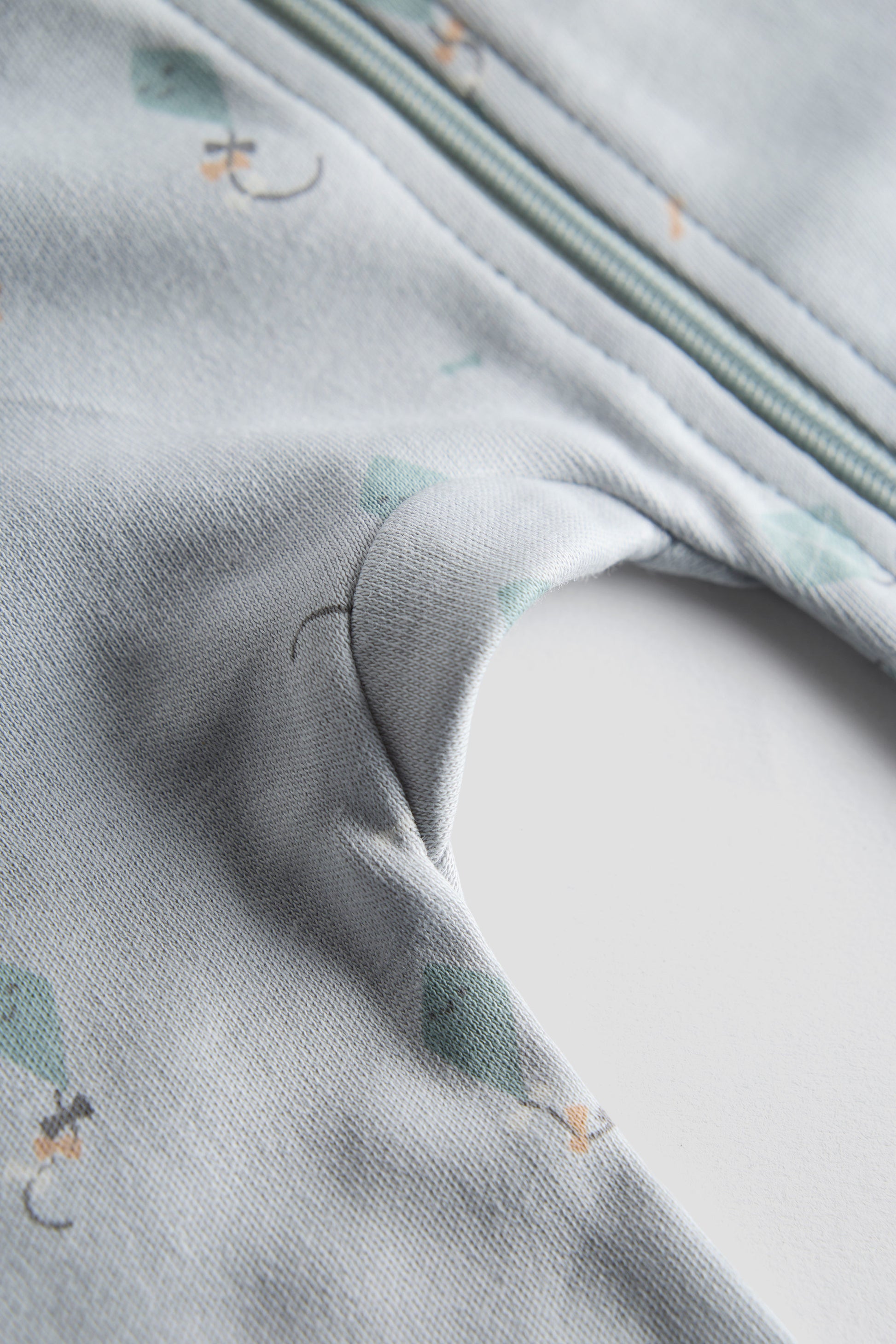 Close-up of a textured fabric with small patterns on a light gray background