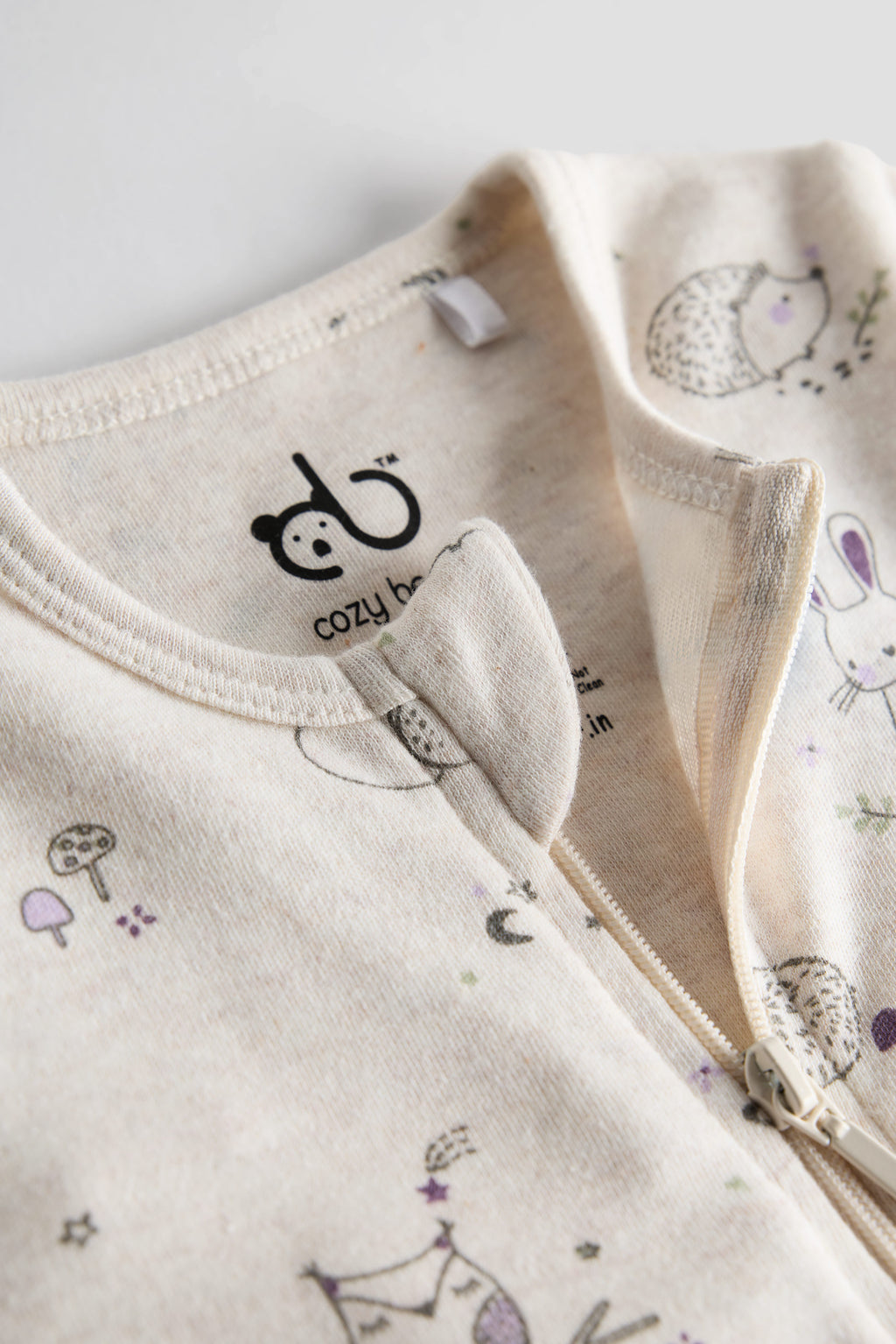 Cream organic cotton baby sleep suit with forest animal print and zipper, certified safe by Cozy Bear.
