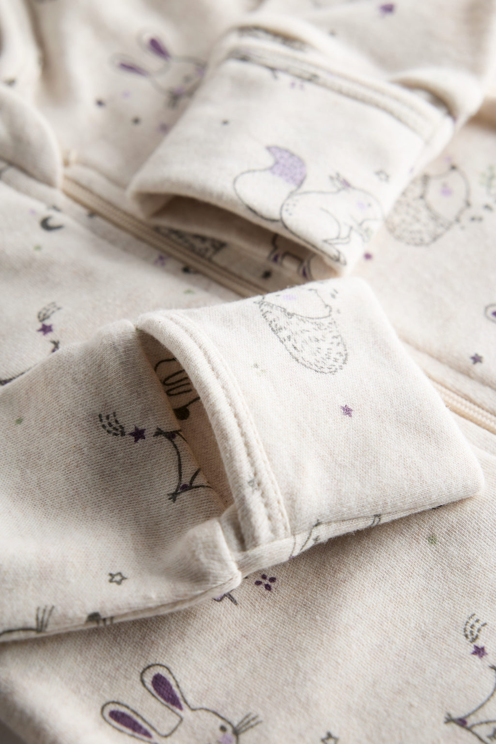 Cream organic cotton baby sleep suit with forest animal print and zipper, certified safe by Cozy Bear.