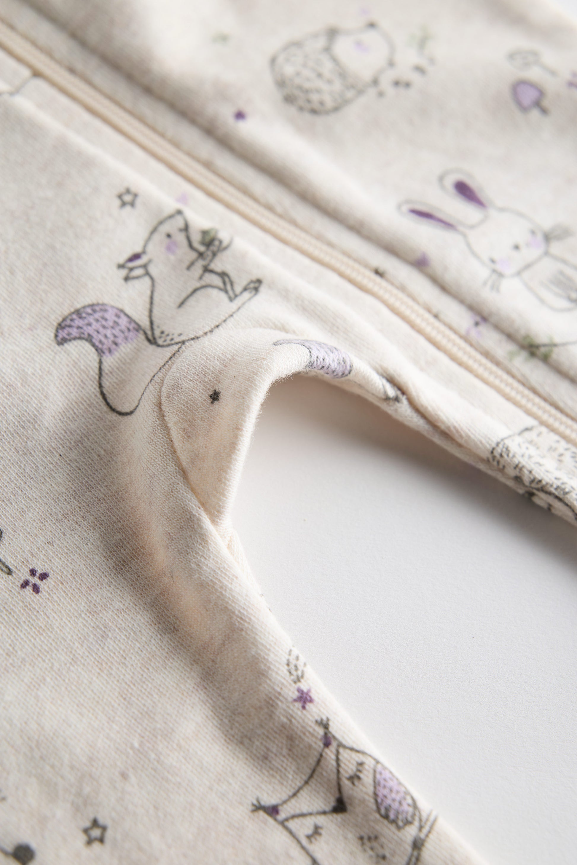 Cream organic cotton baby sleep suit with forest animal print and zipper, certified safe by Cozy Bear.