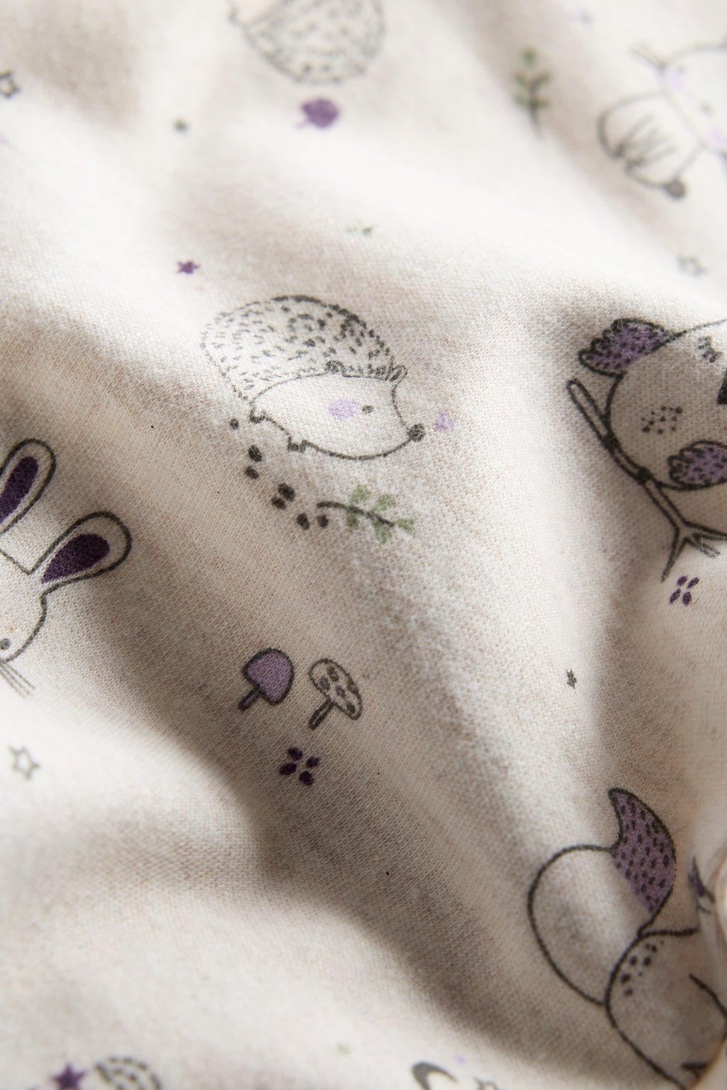 Cream organic cotton baby sleep suit with forest animal print and zipper, certified safe by Cozy Bear.