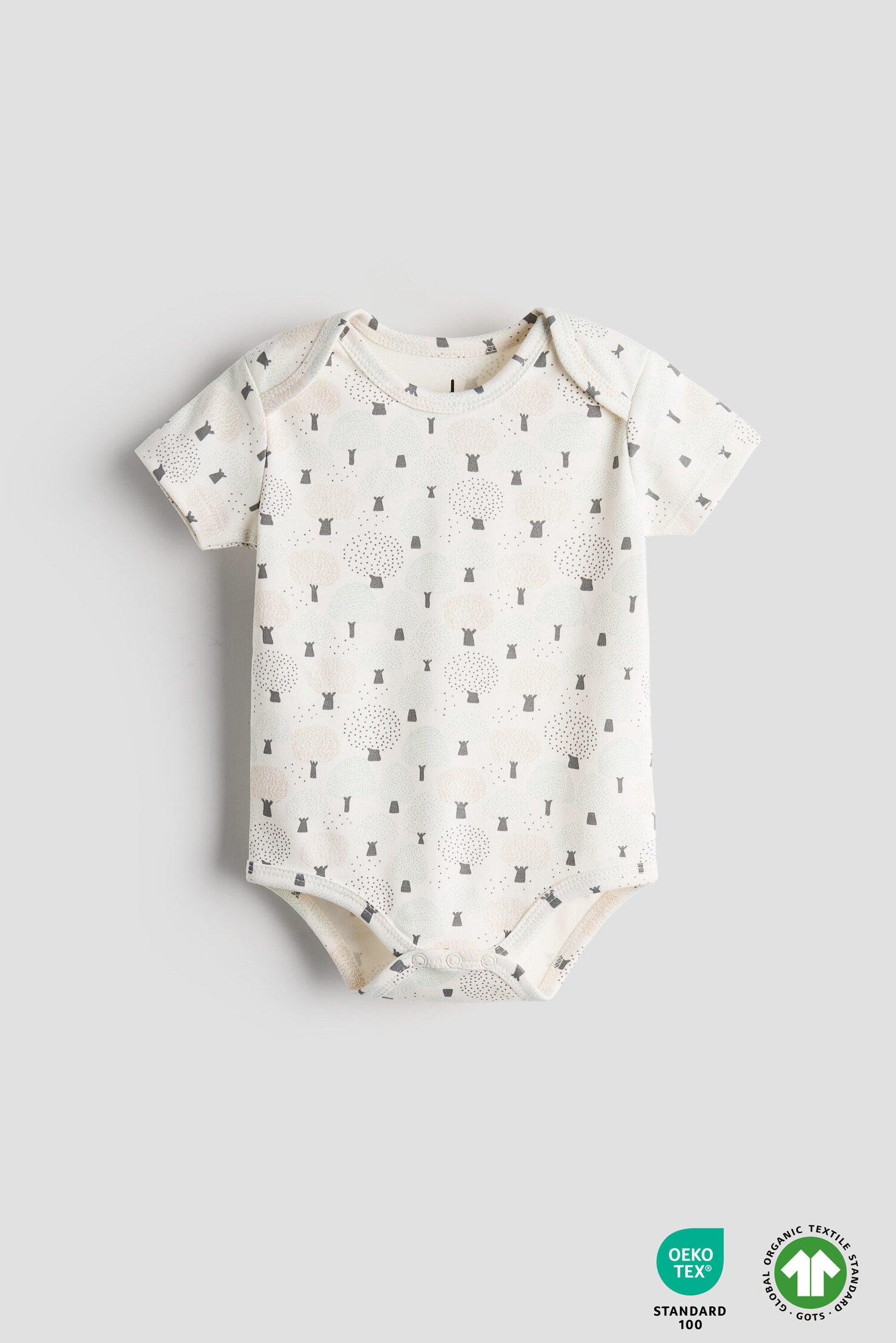 Baby onesie with a pattern on a gray background