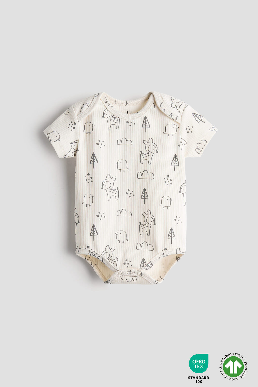 Baby onesie with animal pattern on a light gray background