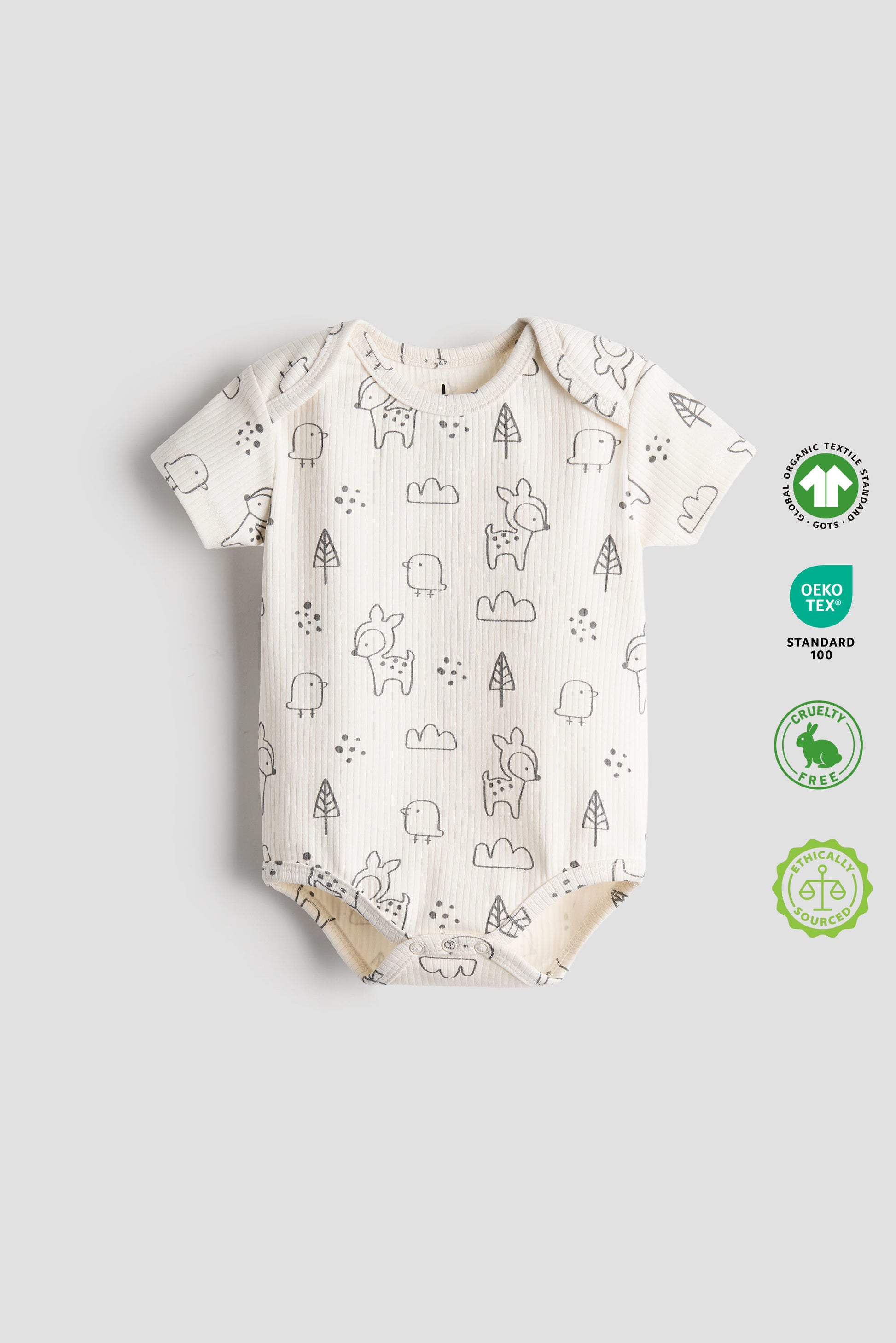 Baby onesie with animal pattern on a light gray background