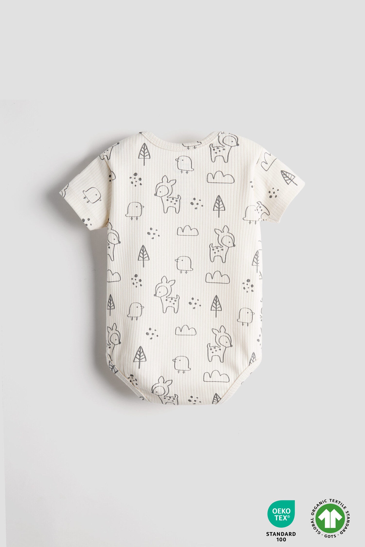 Baby romper with animal pattern on a light gray background