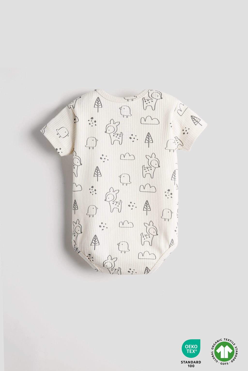 Baby romper with animal pattern on a light gray background