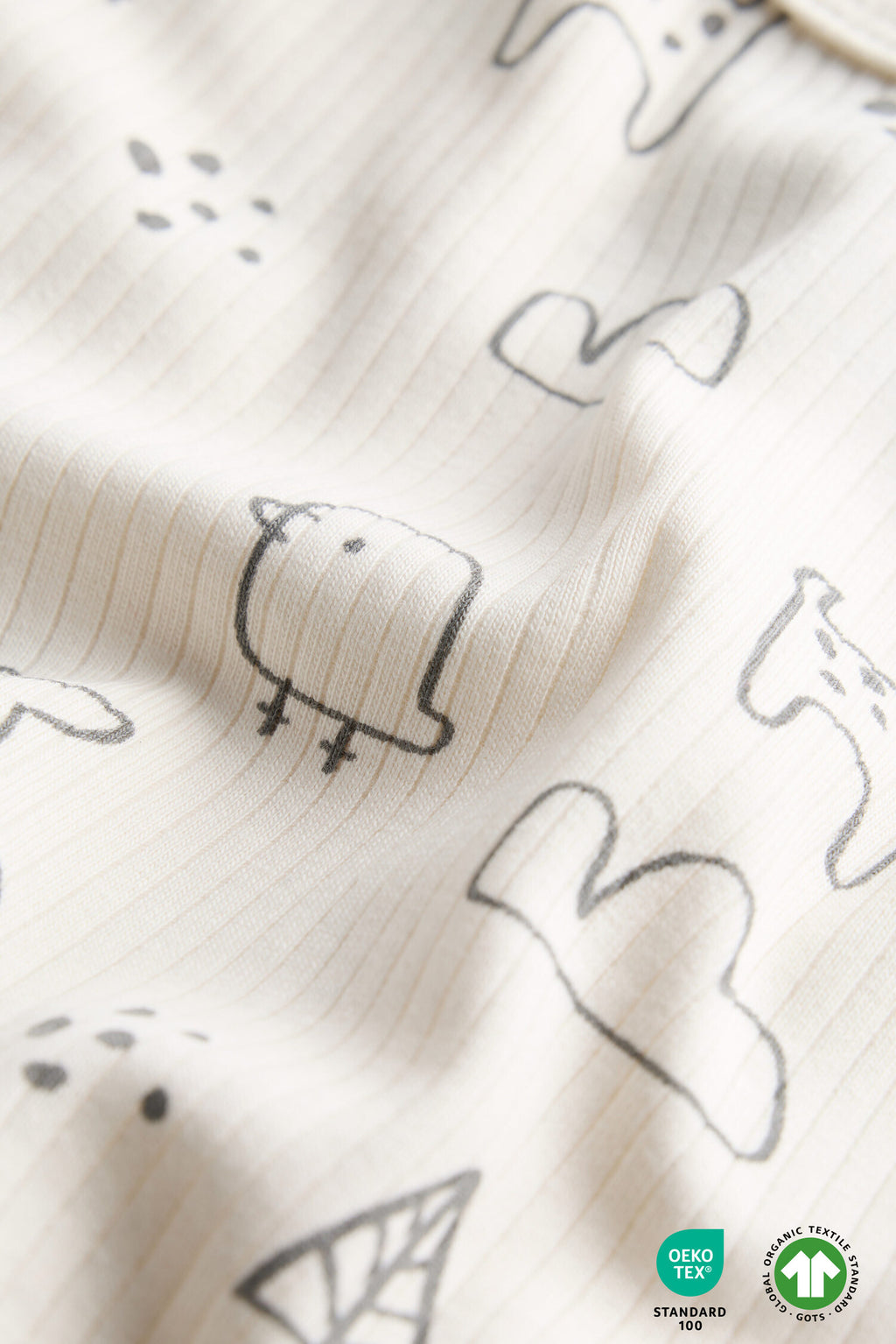 Textured fabric with black animal illustrations on a white background