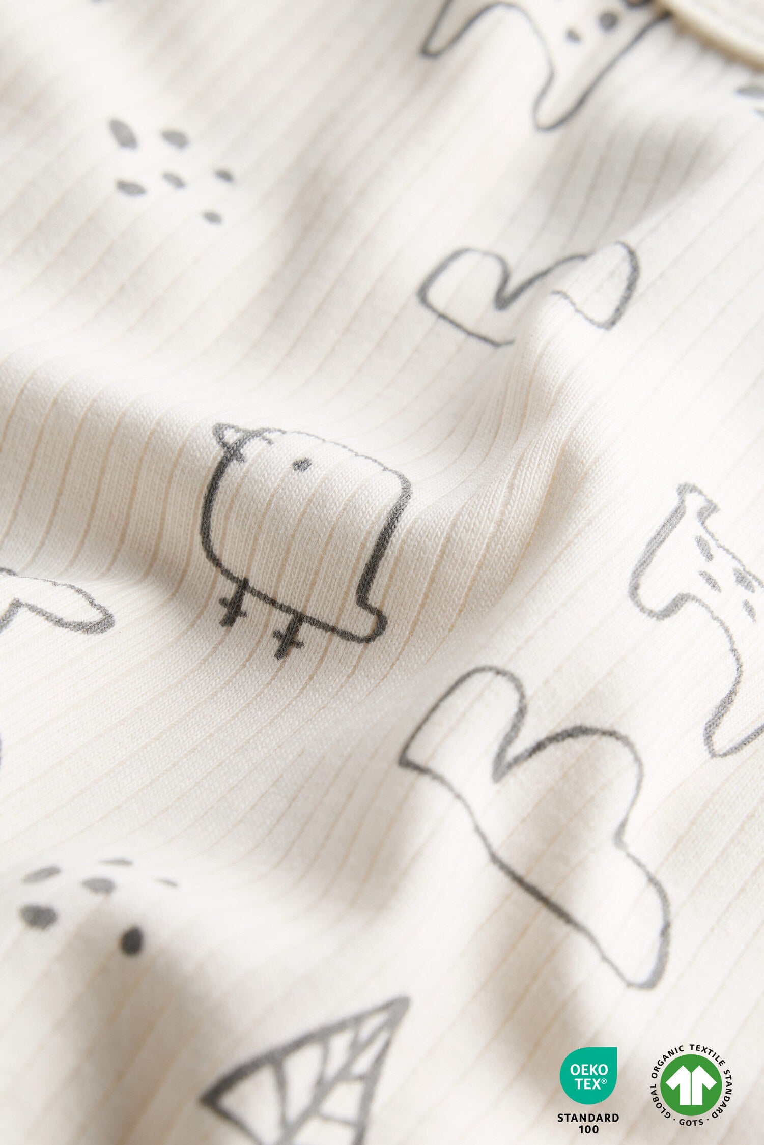 Textured fabric with black animal illustrations on a white background
