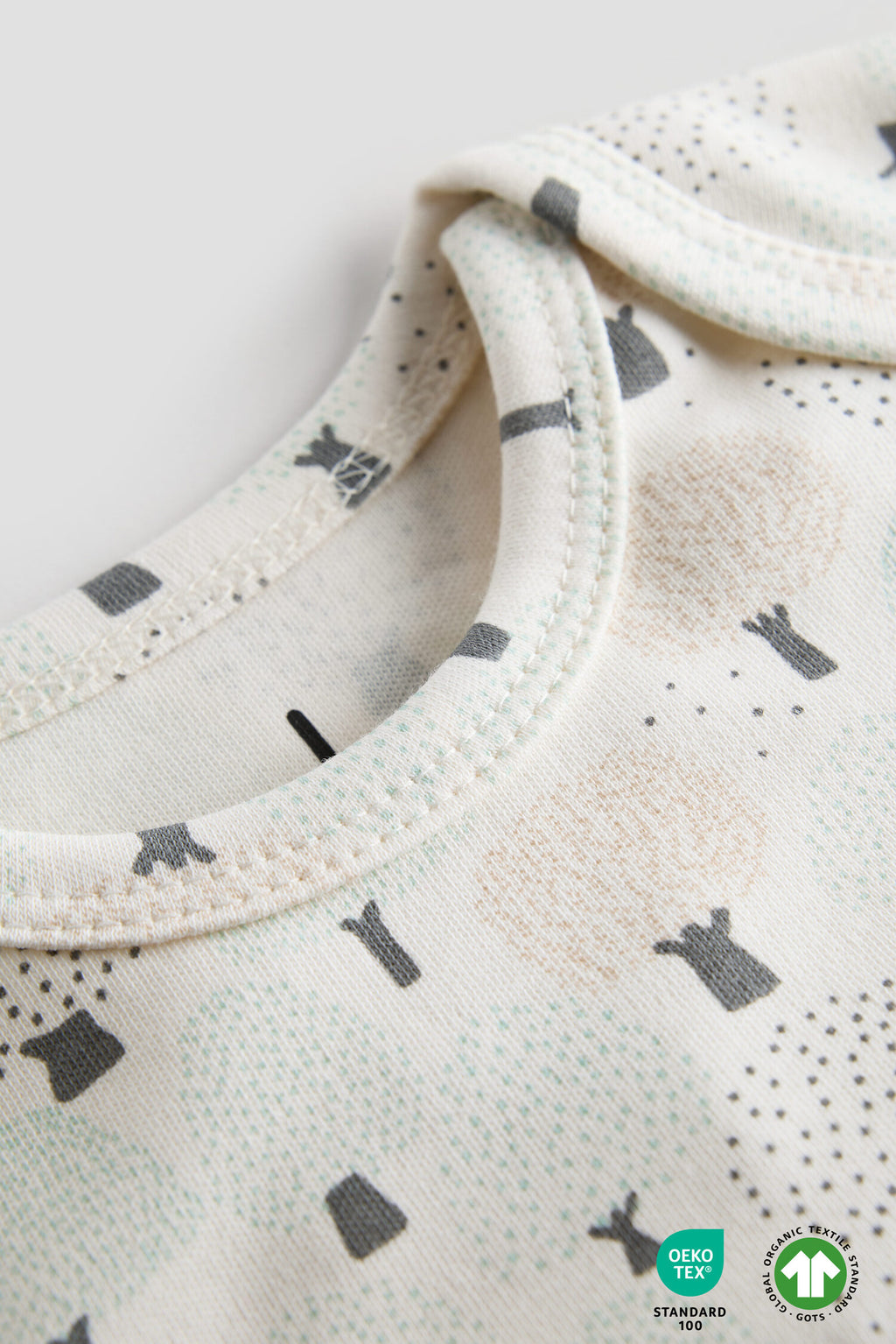 Close-up of a baby bib with black cat pattern on a white background