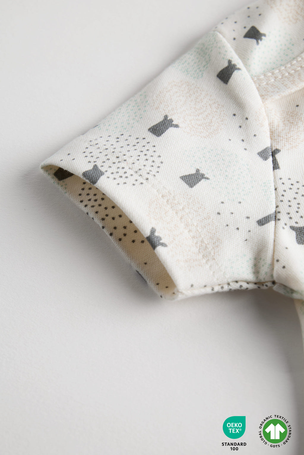 Folded fabric with gray rabbit pattern on a white background